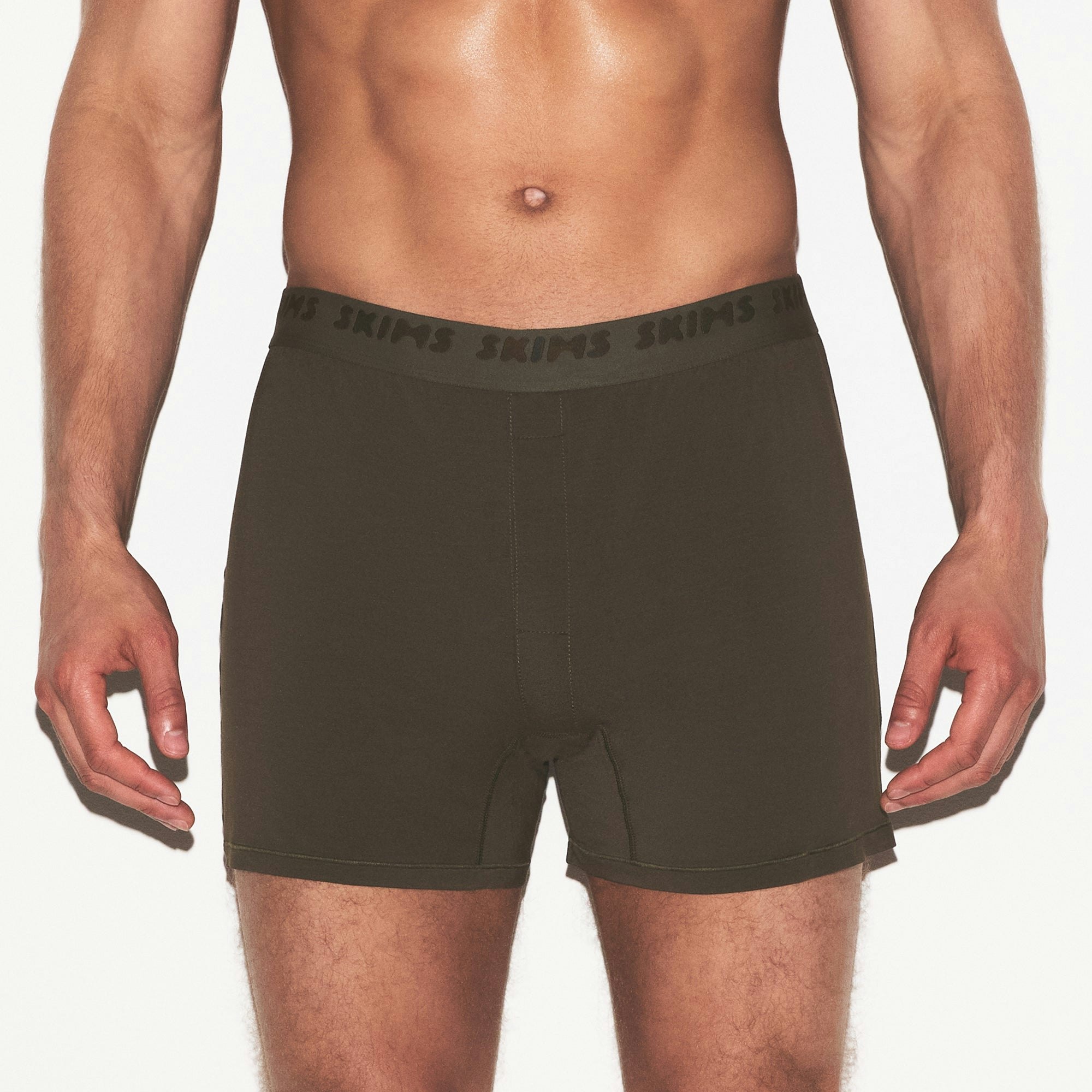 SKIMS STRETCH MENS KNIT BOXER | LODEN ON A MODEL SIDE VIEW @ | FOCUS: 0.0, 1.0, 0.9