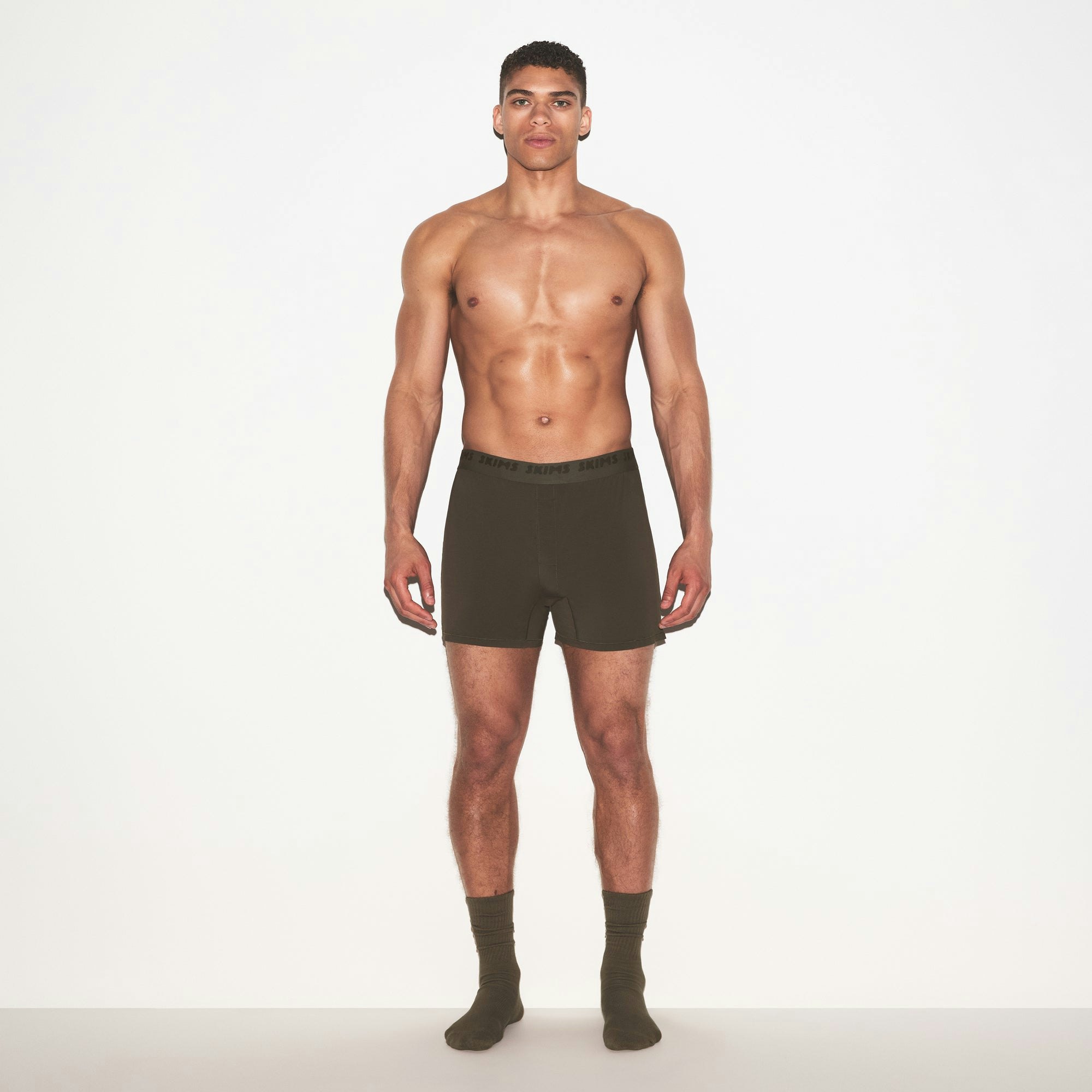SKIMS STRETCH MENS KNIT BOXER | LODEN ON A MODEL FRONT VIEW @ | FOCUS: 0.0, 1.0, 0.9