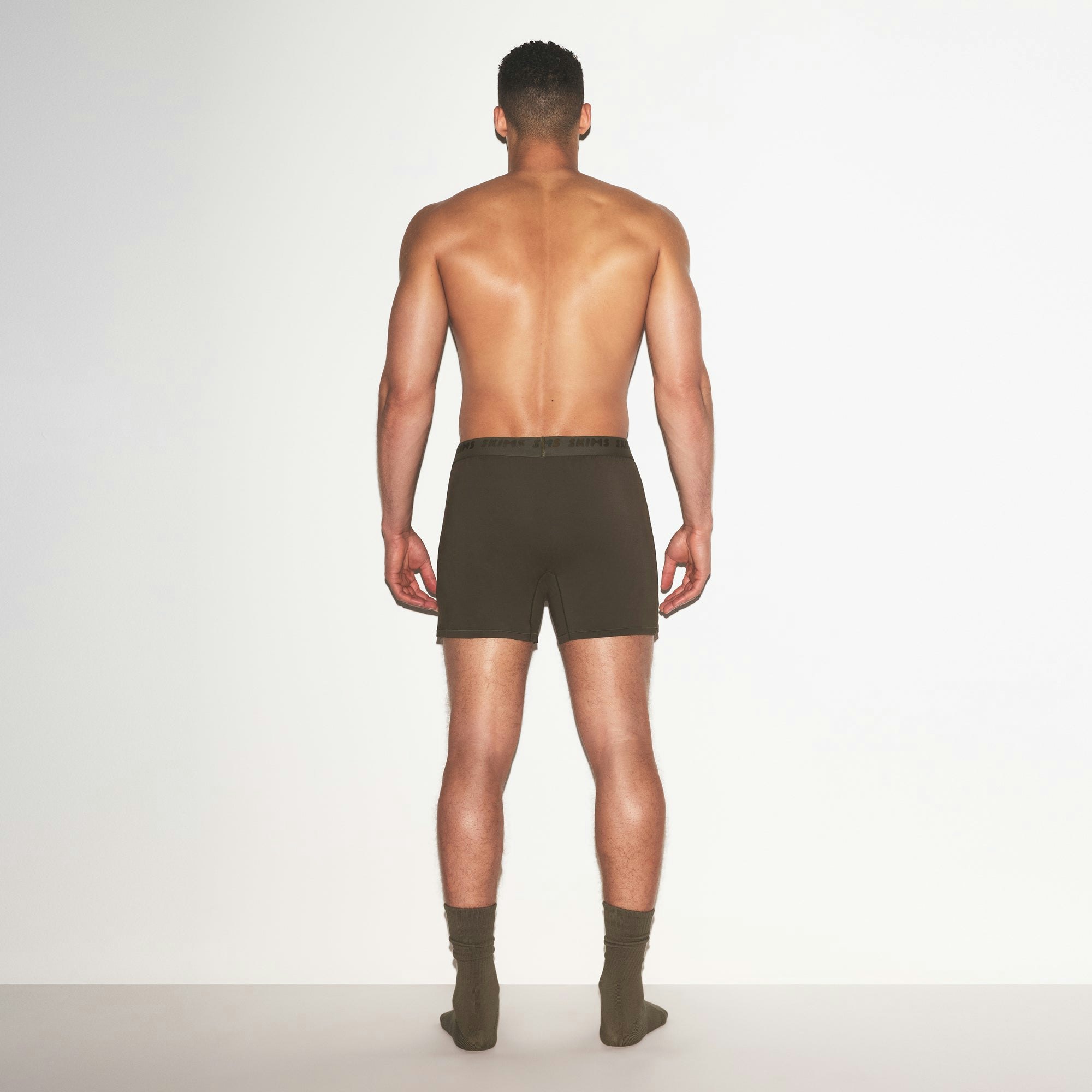 SKIMS STRETCH MENS KNIT BOXER | LODEN ON A MODEL FRONT VIEW @ | FOCUS: 0.0, 1.0, 0.9