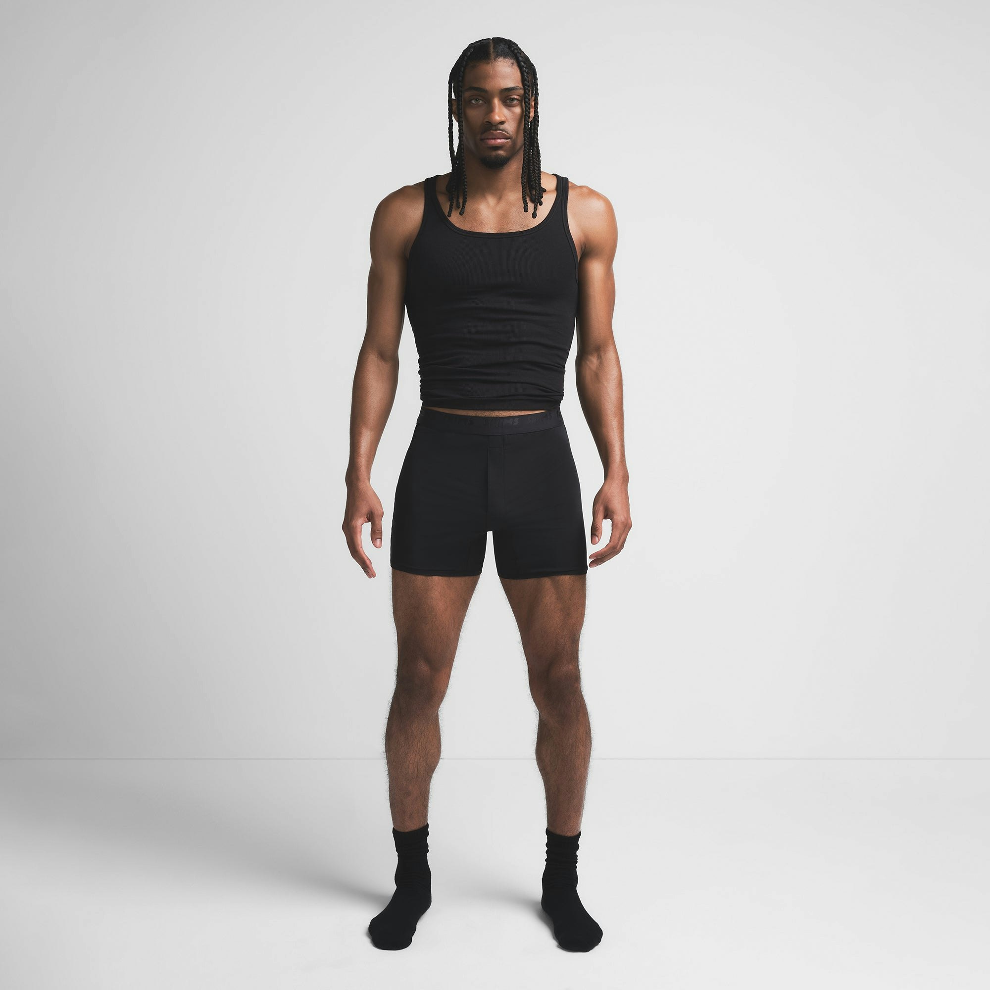 SKIMS STRETCH MENS KNIT BOXER | OBSIDIAN ON A MODEL FRONT VIEW @ | FOCUS: 0.9, 0.1, 0.7