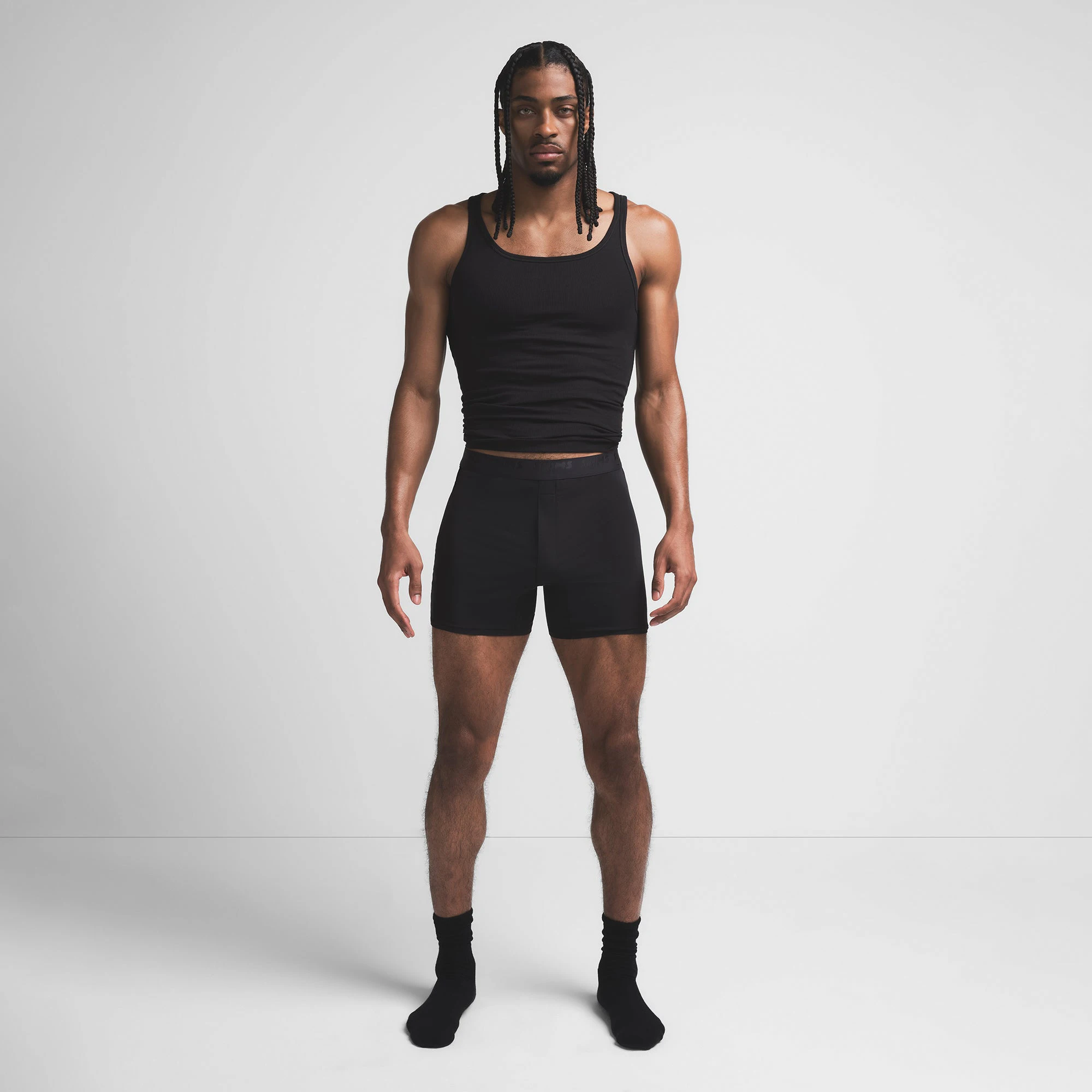 SKIMS STRETCH MENS KNIT BOXER | OBSIDIAN ON A MODEL FRONT VIEW @ | FOCUS: 0.9, 0.1, 0.7