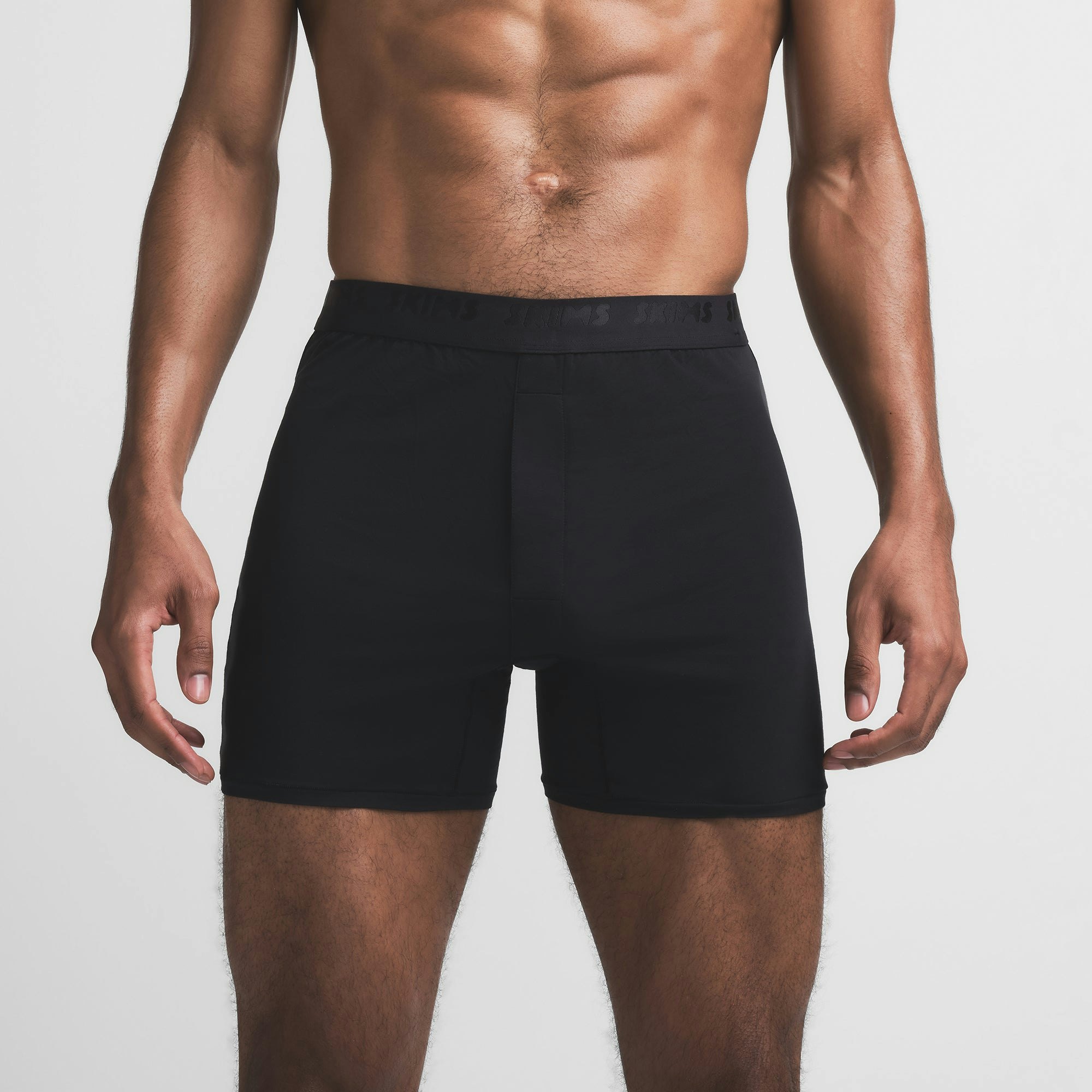 SKIMS STRETCH MENS KNIT BOXER | OBSIDIAN ON A MODEL FRONT VIEW @ | FOCUS: 0.9, 0.1, 0.7