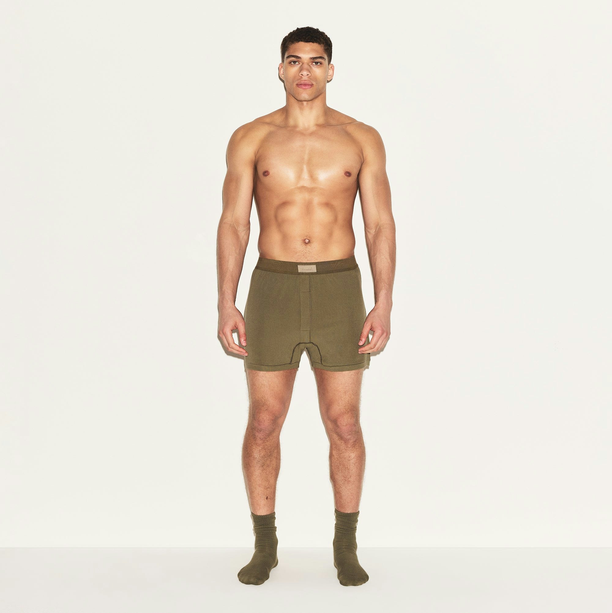 SKIMS COTTON MENS KNIT BOXER | ARMY ON A MODEL FRONT VIEW | FOCUS: 0.0, 1.0, 0.9