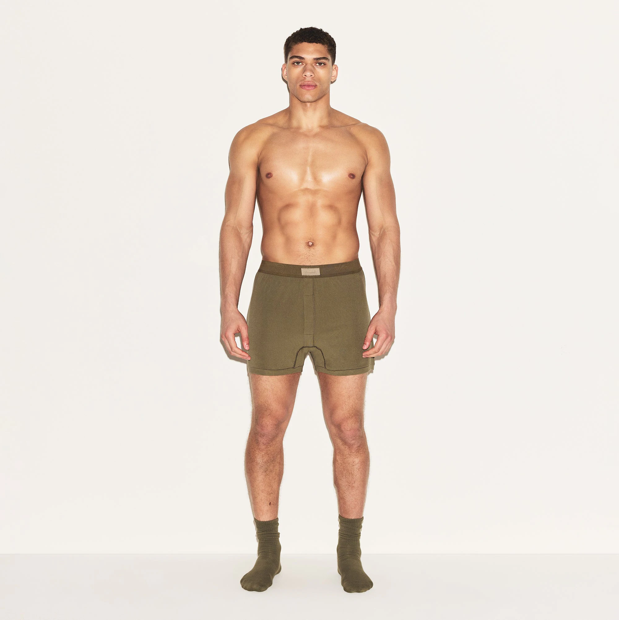 SKIMS COTTON MENS KNIT BOXER | ARMY ON A MODEL FRONT VIEW | FOCUS: 0.0, 1.0, 0.9