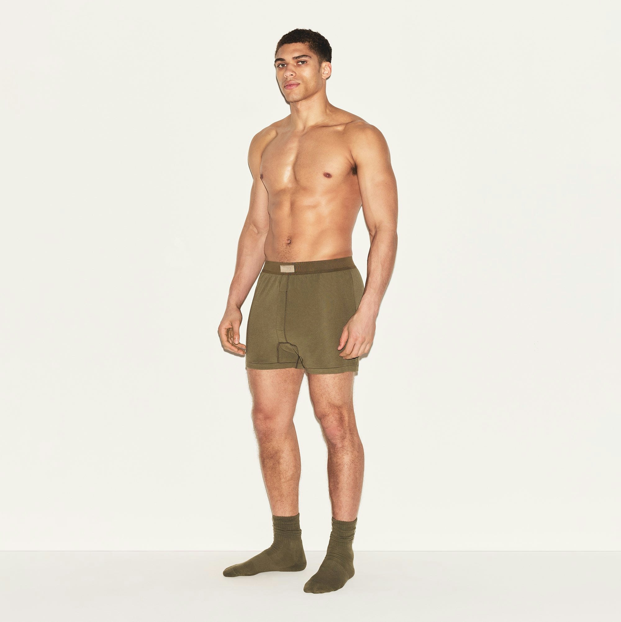 SKIMS COTTON MENS KNIT BOXER | ARMY ON A MODEL SIDE VIEW | FOCUS: 0.0, 1.0, 0.9