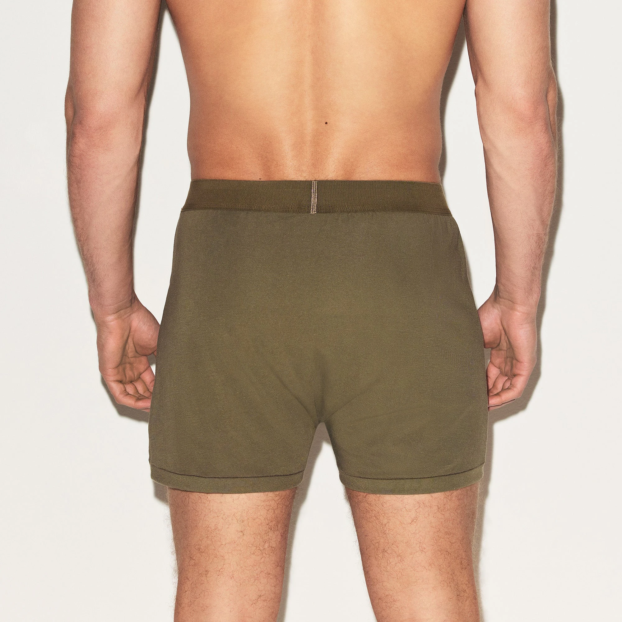 SKIMS COTTON MENS KNIT BOXER | ARMY ON A MODEL BACK VIEW | FOCUS: 0.0, 1.0, 0.9