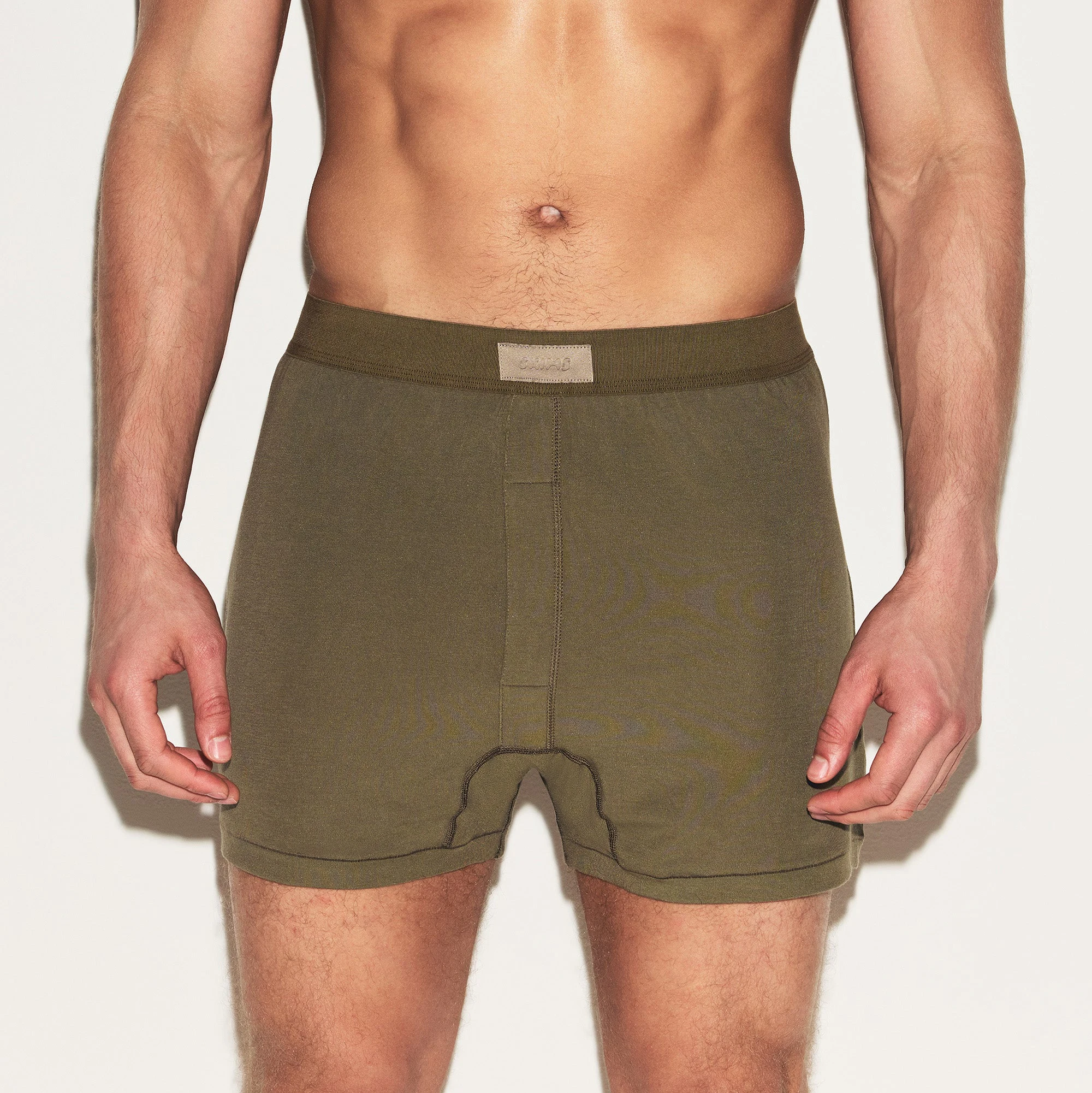 SKIMS COTTON MENS KNIT BOXER | ARMY ON A MODEL FRONT VIEW | FOCUS: 0.0, 1.0, 0.9