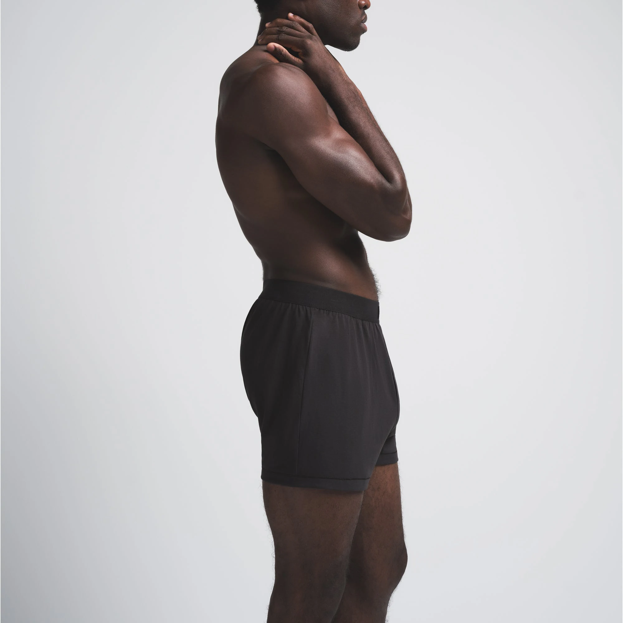 SKIMS COTTON MENS KNIT BOXER | ONYX ON A MODEL SIDE VIEW