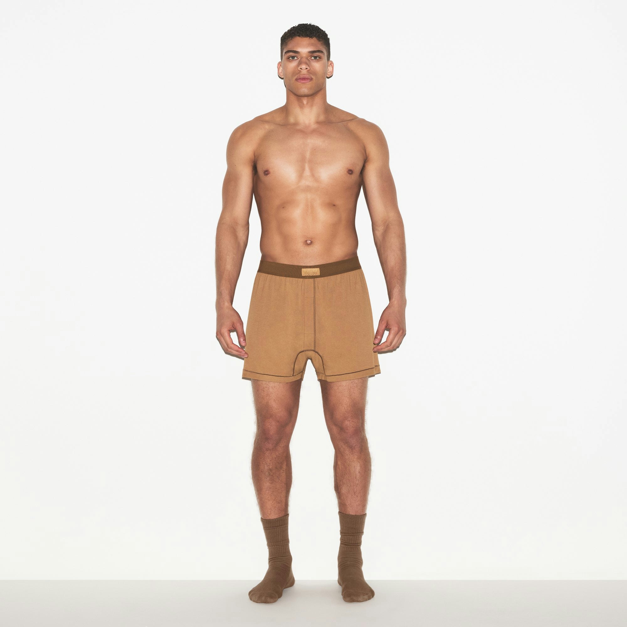 SKIMS COTTON MENS KNIT BOXER | RUSSET ON A MODEL FRONT VIEW | FOCUS: 0.0, 1.0, 0.9