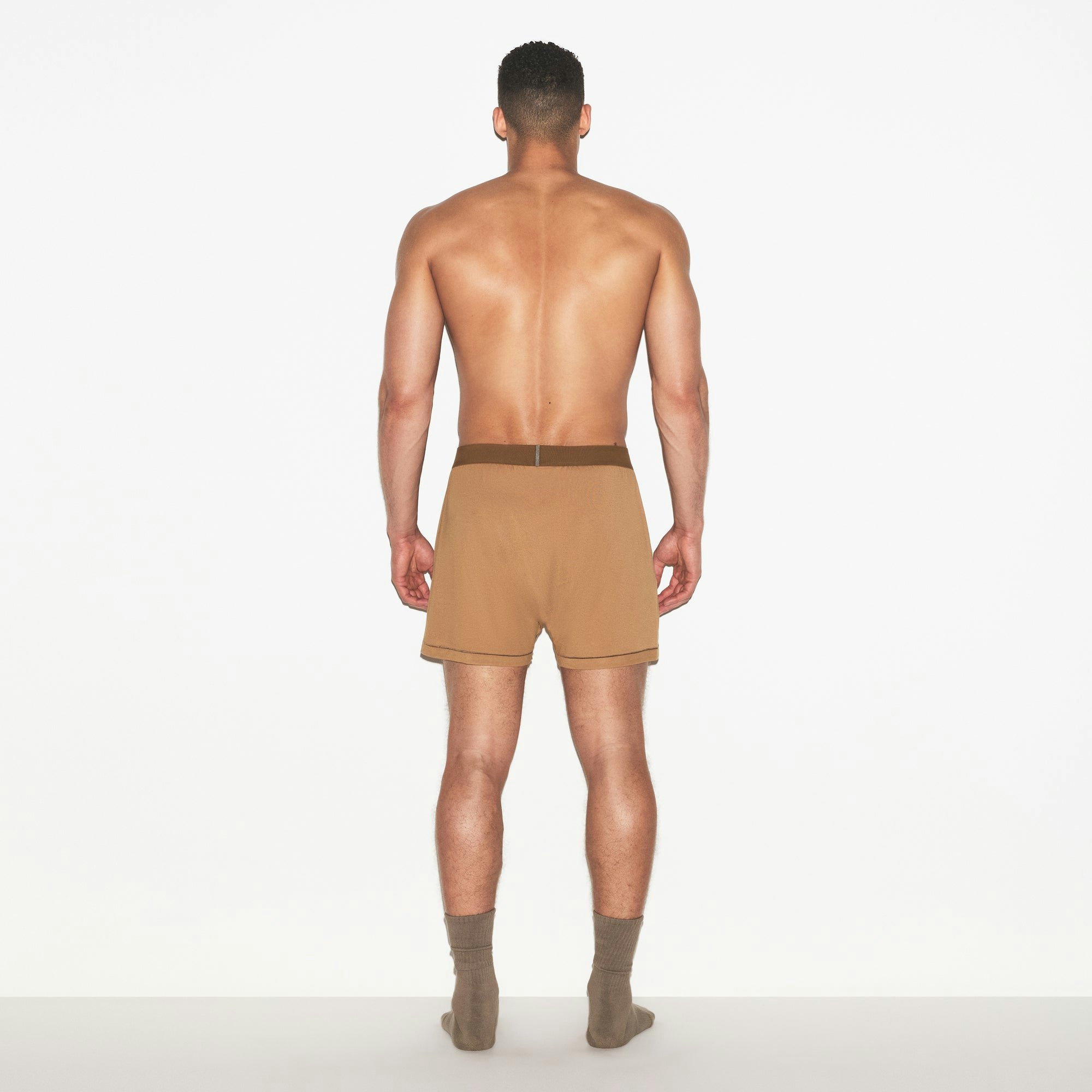SKIMS COTTON MENS KNIT BOXER | RUSSET ON A MODEL FRONT VIEW | FOCUS: 0.0, 1.0, 0.9