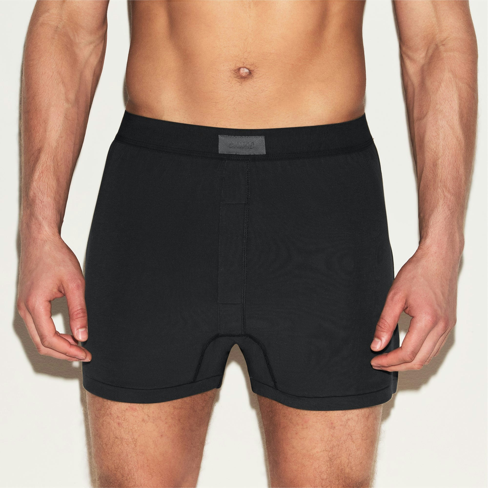 SKIMS COTTON MENS KNIT BOXER 3-PACK | HEATHER MULTI ON A MODEL SIDE VIEW | FOCUS: 0.0, 1.0, 0.9