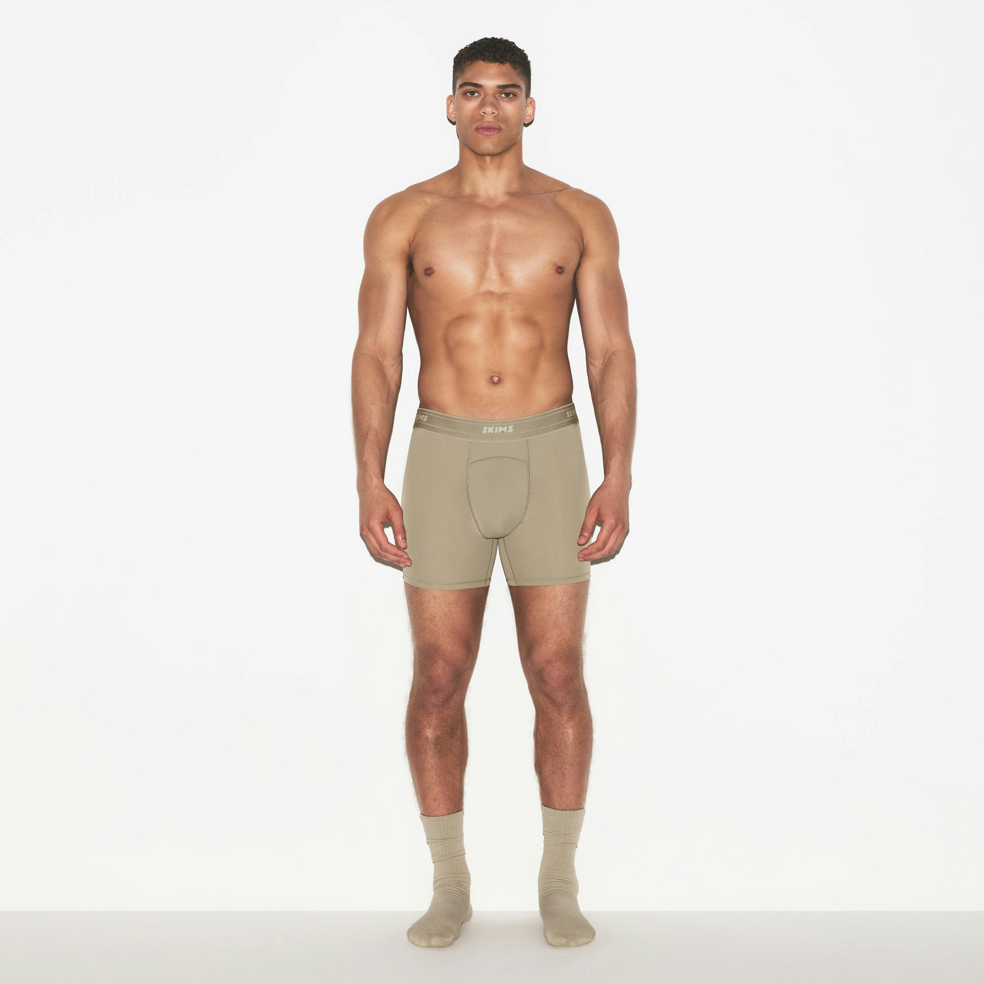 SKIMS SPORT MENS 5" BOXER BRIEF 3-PACK | DUNE MULTI ON A MODEL FRONT VIEW | FOCUS: 0.0, 1.0, 0.9