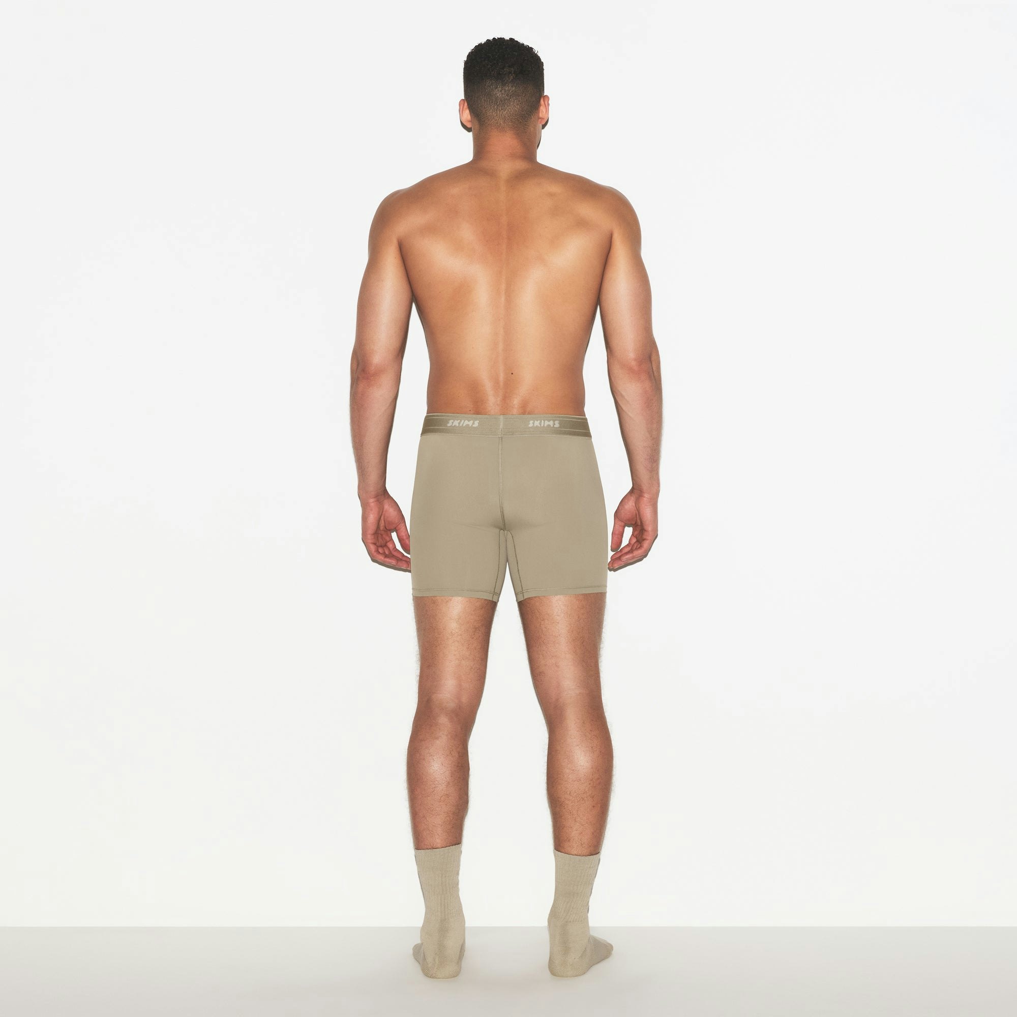 SKIMS SPORT MENS 5 INCH BOXER BRIEF 3-PACK | DUNE MULTI ON A MODEL FRONT VIEW | FOCUS: 0.0, 1.0, 0.9