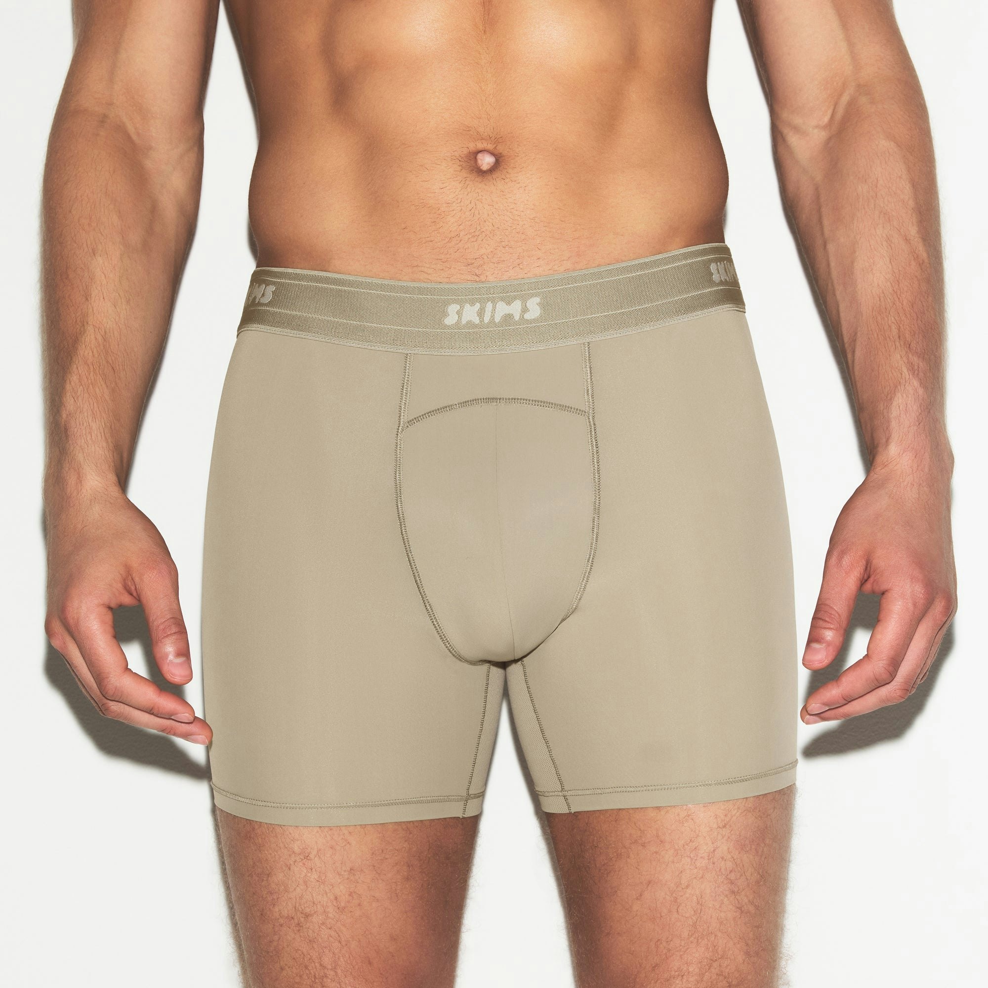 SKIMS SPORT MENS 5 INCH BOXER BRIEF 3-PACK | DUNE MULTI ON A MODEL SIDE VIEW | FOCUS: 0.0, 1.0, 0.9