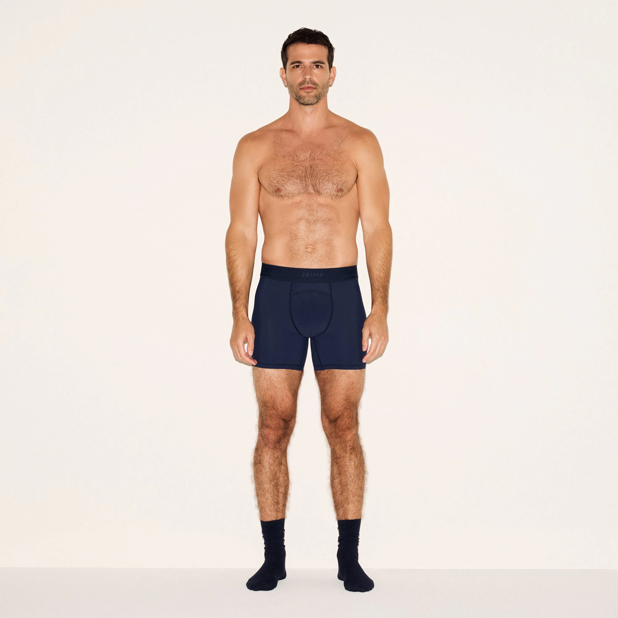 SKIMS SPORT MENS 5 INCH BOXER BRIEF 3-PACK | NAVY SMOKE MULTI ON A MODEL FRONT VIEW | FOCUS: 0.0, 1.0, 0.9