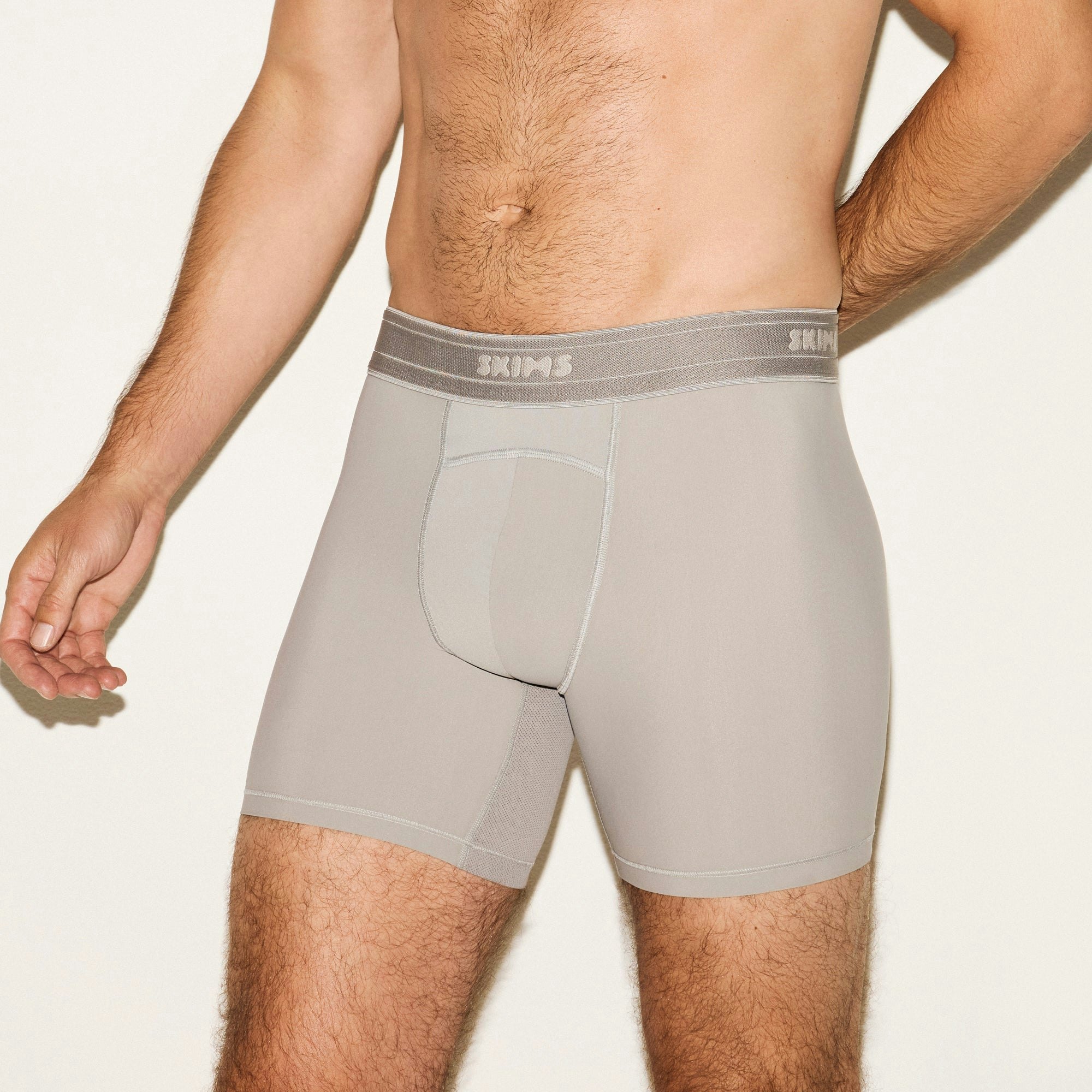 SKIMS SPORT MENS 5 INCH BOXER BRIEF 3-PACK | NAVY SMOKE MULTI ON A MODEL SIDE VIEW | FOCUS: 0.0, 1.0, 0.9