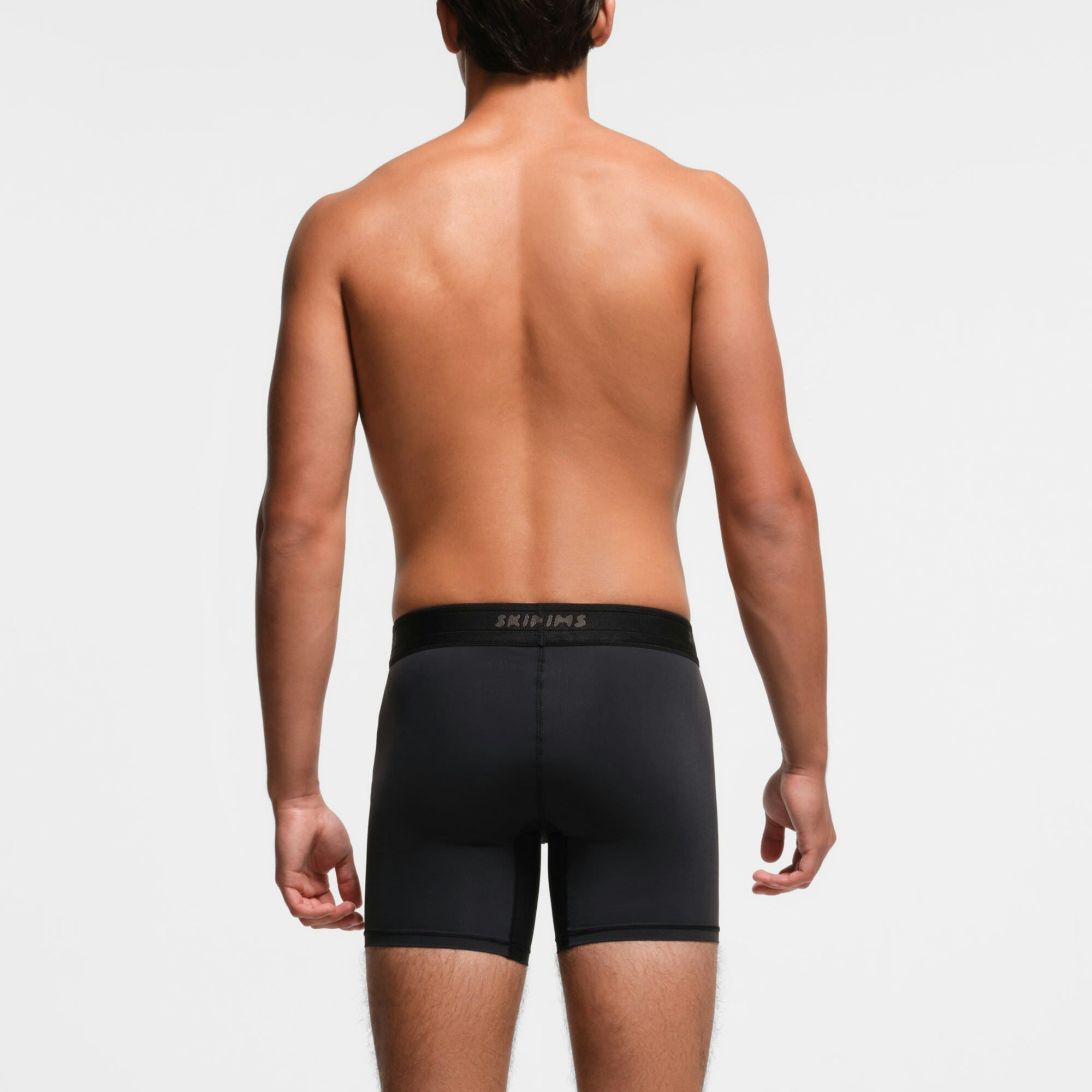 SKIMS SPORT MENS 5" BOXER BRIEF 3-PACK | OBSIDIAN ON A MODEL BACK VIEW