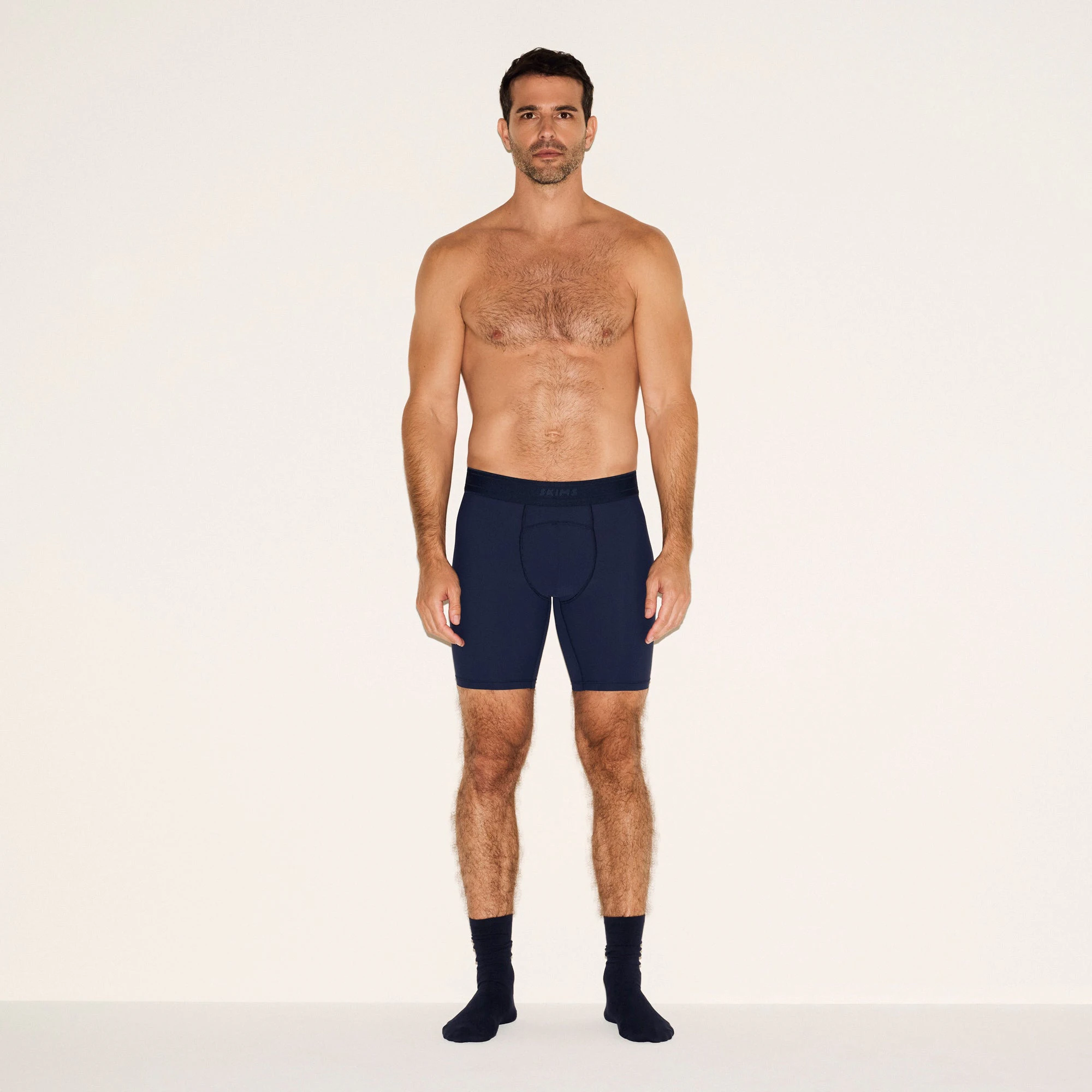 SKIMS SPORT MENS 7 INCH BOXER BRIEF 3-PACK | NAVY SMOKE MULTI ON A MODEL FRONT VIEW | FOCUS: 0.0, 1.0, 0.9