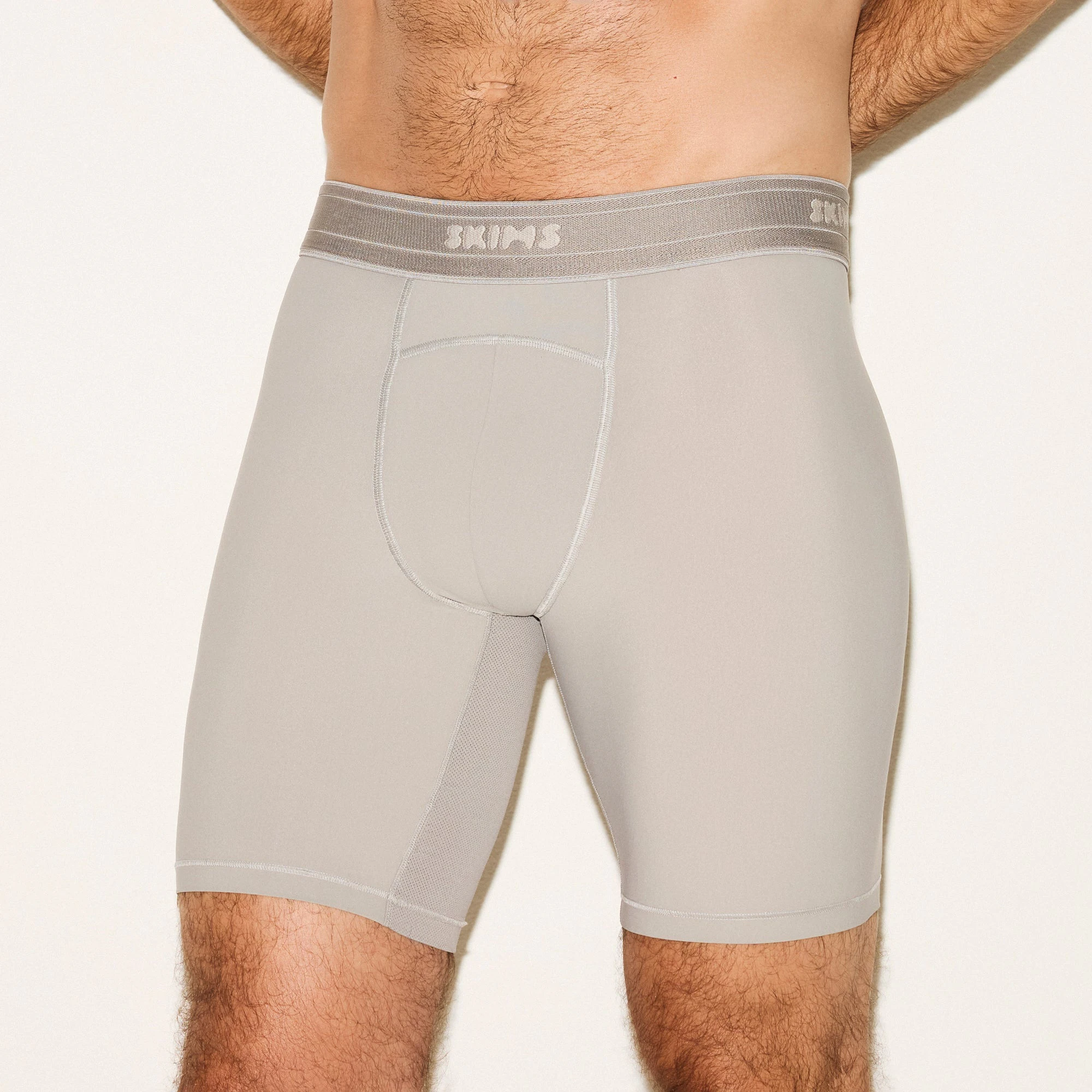 SKIMS SPORT MENS 7 INCH BOXER BRIEF 3-PACK | NAVY SMOKE MULTI ON A MODEL SIDE VIEW | FOCUS: 0.0, 1.0, 0.9