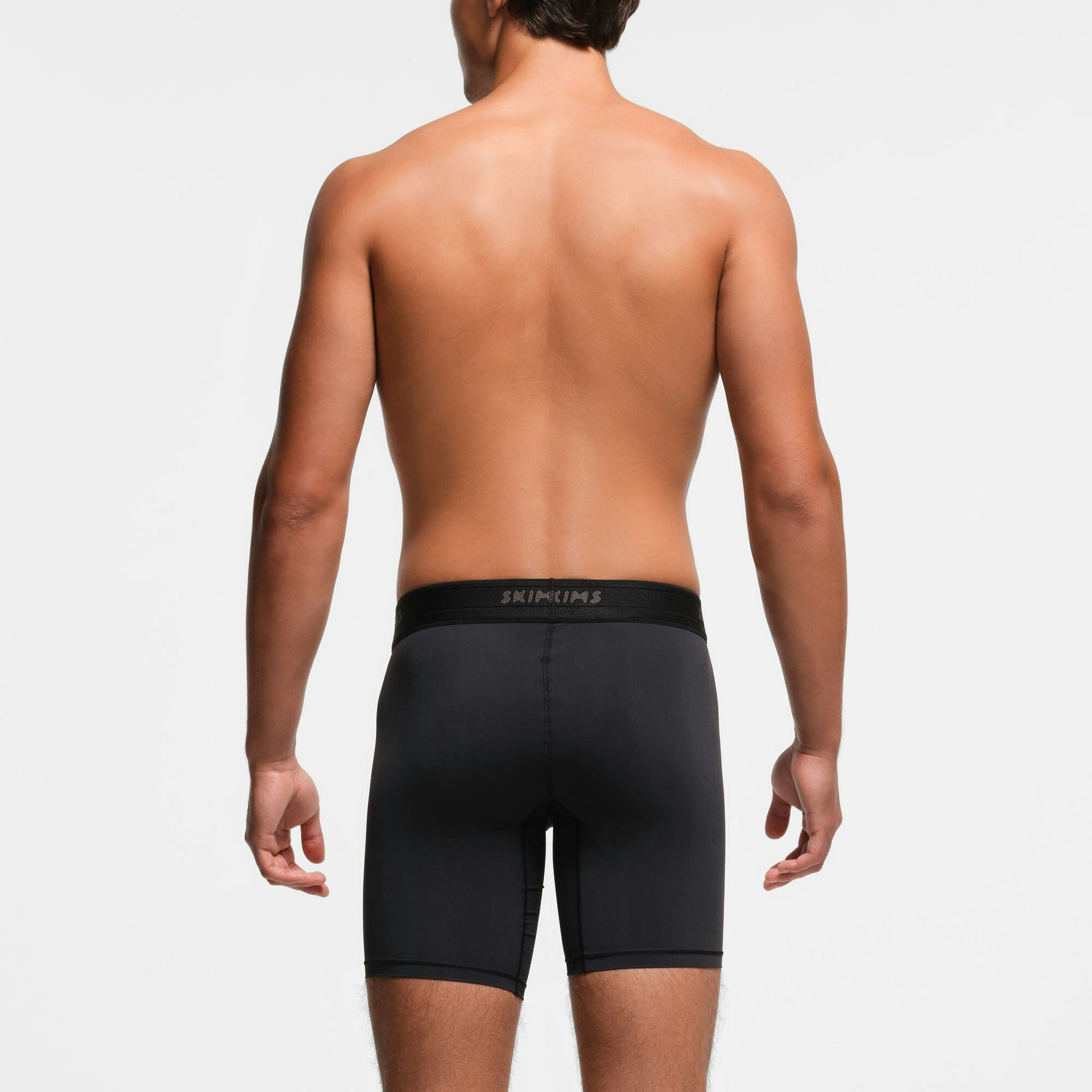 SKIMS SPORT MENS 7" BOXER BRIEF 3-PACK | OBSIDIAN ON A MODEL BACK VIEW