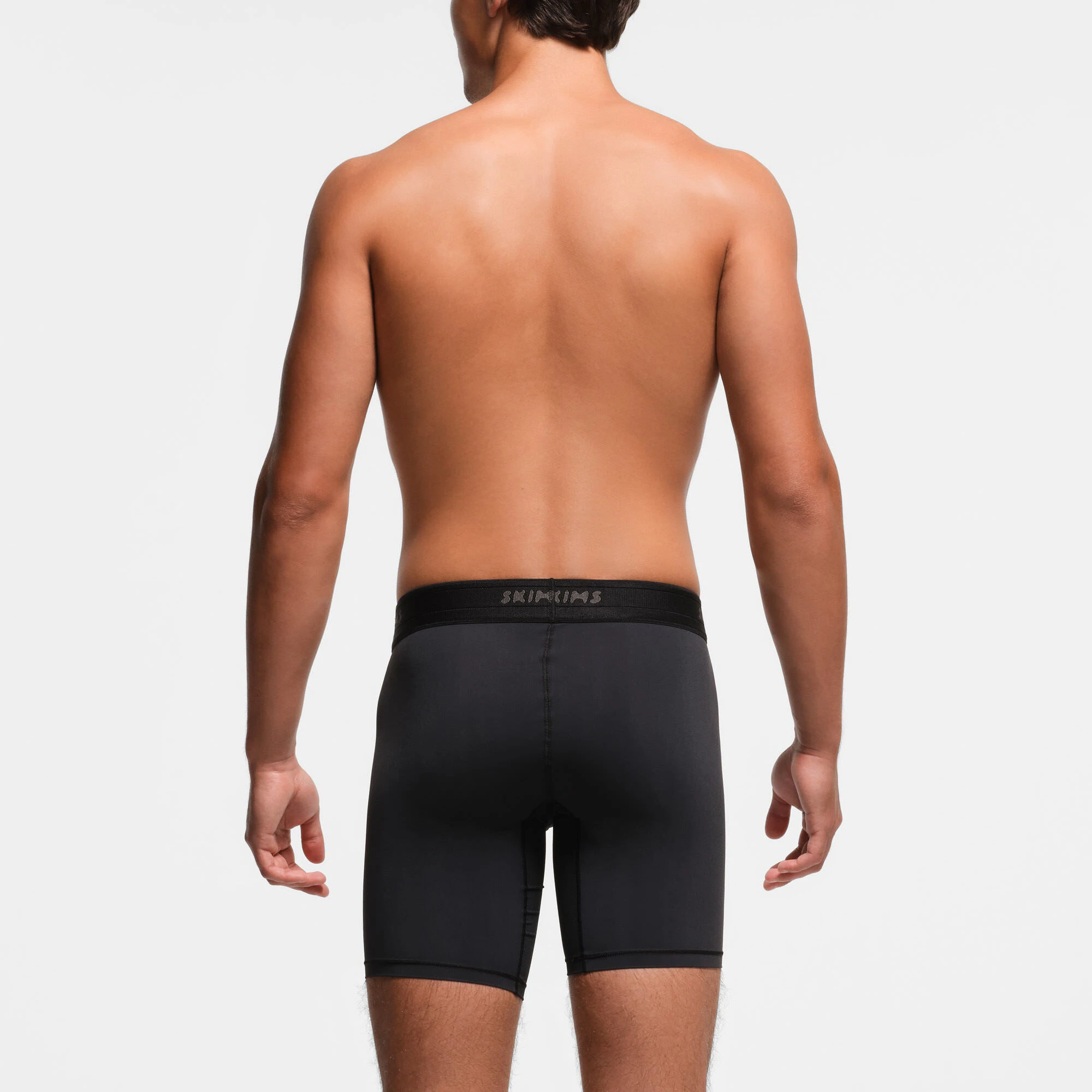 SKIMS SPORT MENS 7" BOXER BRIEF 3-PACK | OBSIDIAN ON A MODEL BACK VIEW