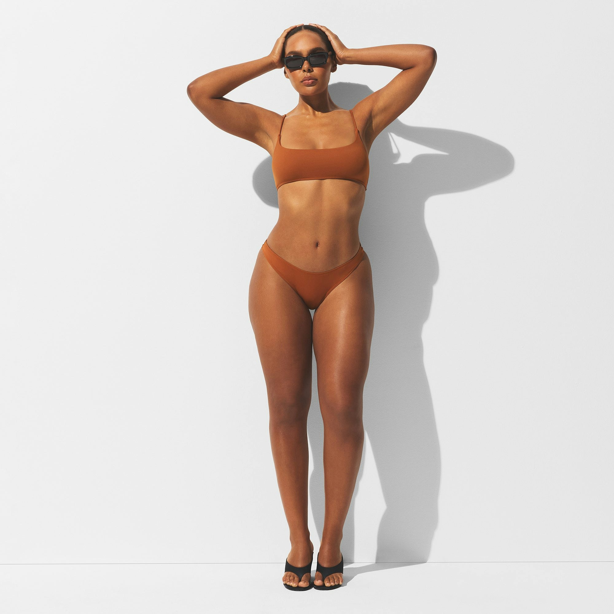 MINIMAL SWIM BIKINI BOTTOM | BRONZE ON A MODEL FRONT VIEW | FOCUS: 0.0, 1.0, 0.9