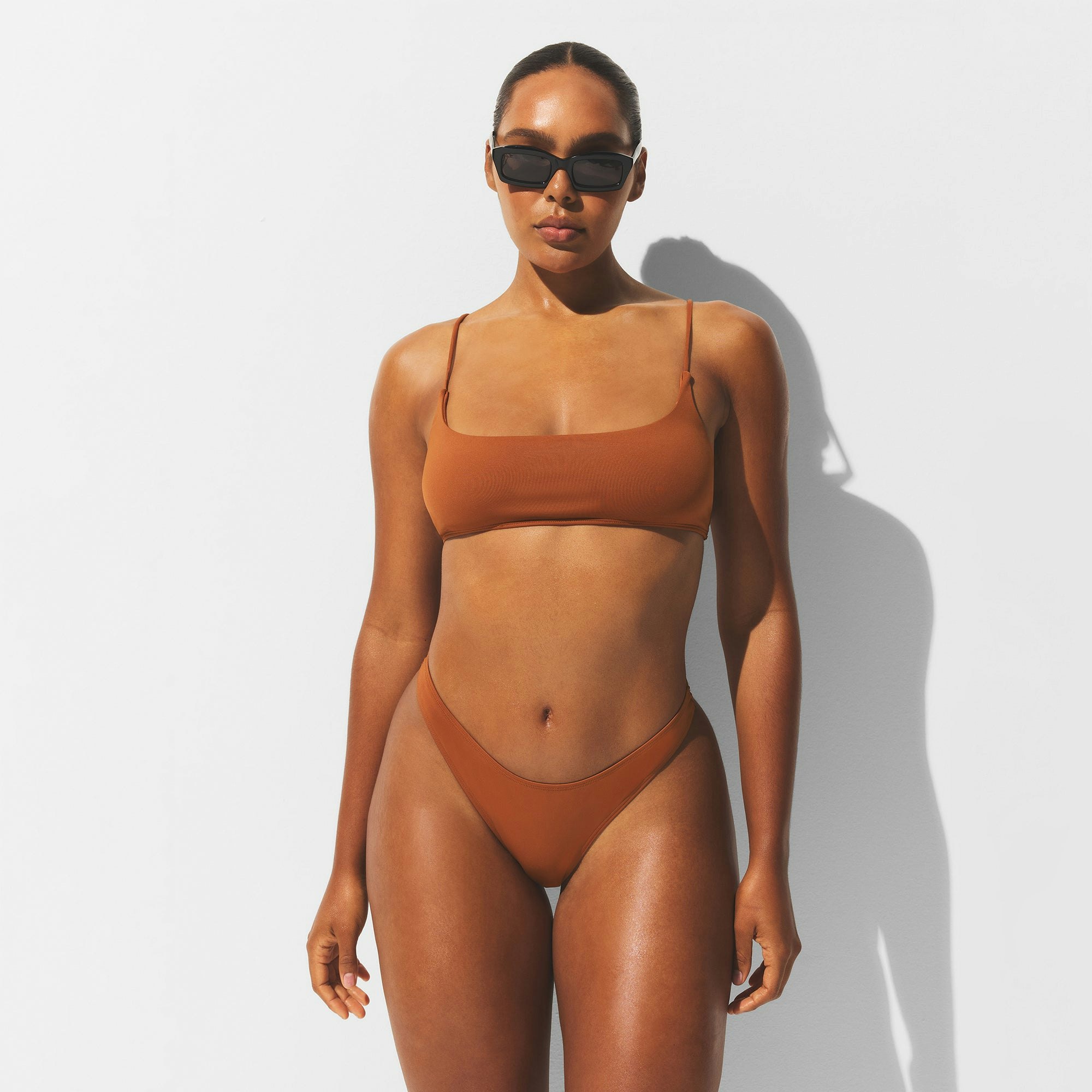 MINIMAL SWIM BIKINI BOTTOM | BRONZE ON A MODEL FRONT VIEW | FOCUS: 0.0, 1.0, 0.9