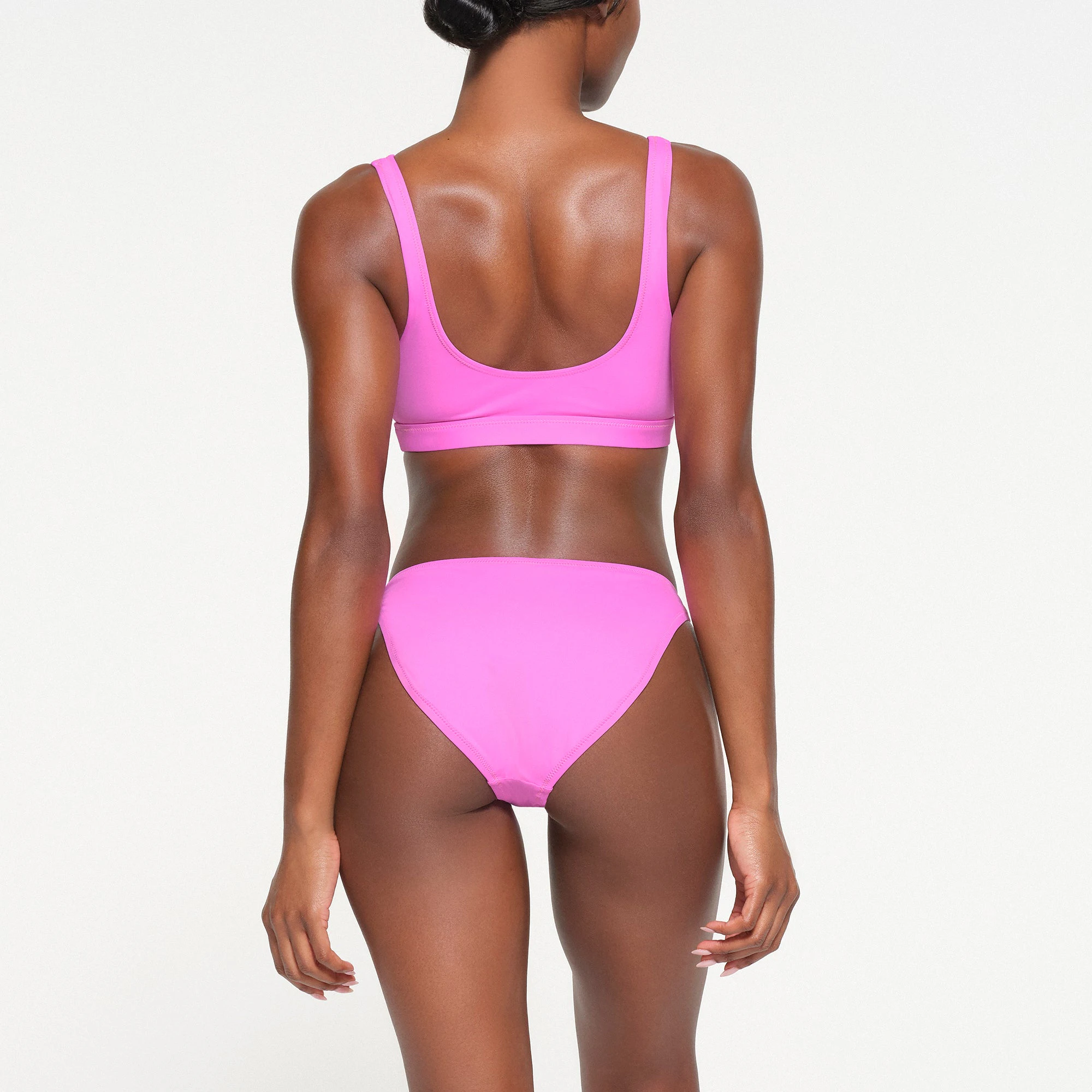 SIGNATURE SWIM MID COVERAGE BOTTOMS | NEON ORCHID ON A MODEL BACK VIEW