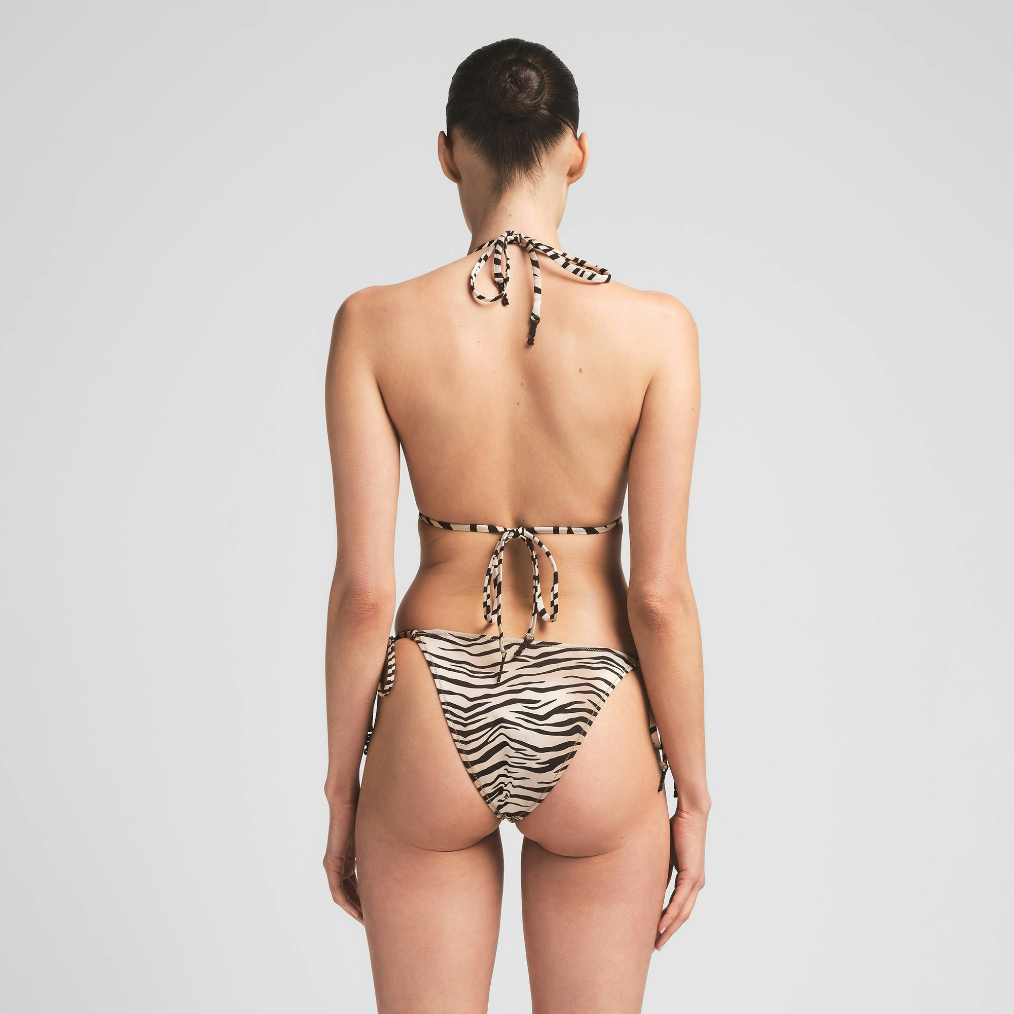 SIGNATURE SWIM DIPPED TIE BIKINI BOTTOM | CHAMPAGNE TIGER PRINT ON A MODEL BACK VIEW | FOCUS: 0.0, 1.0, 0.9
