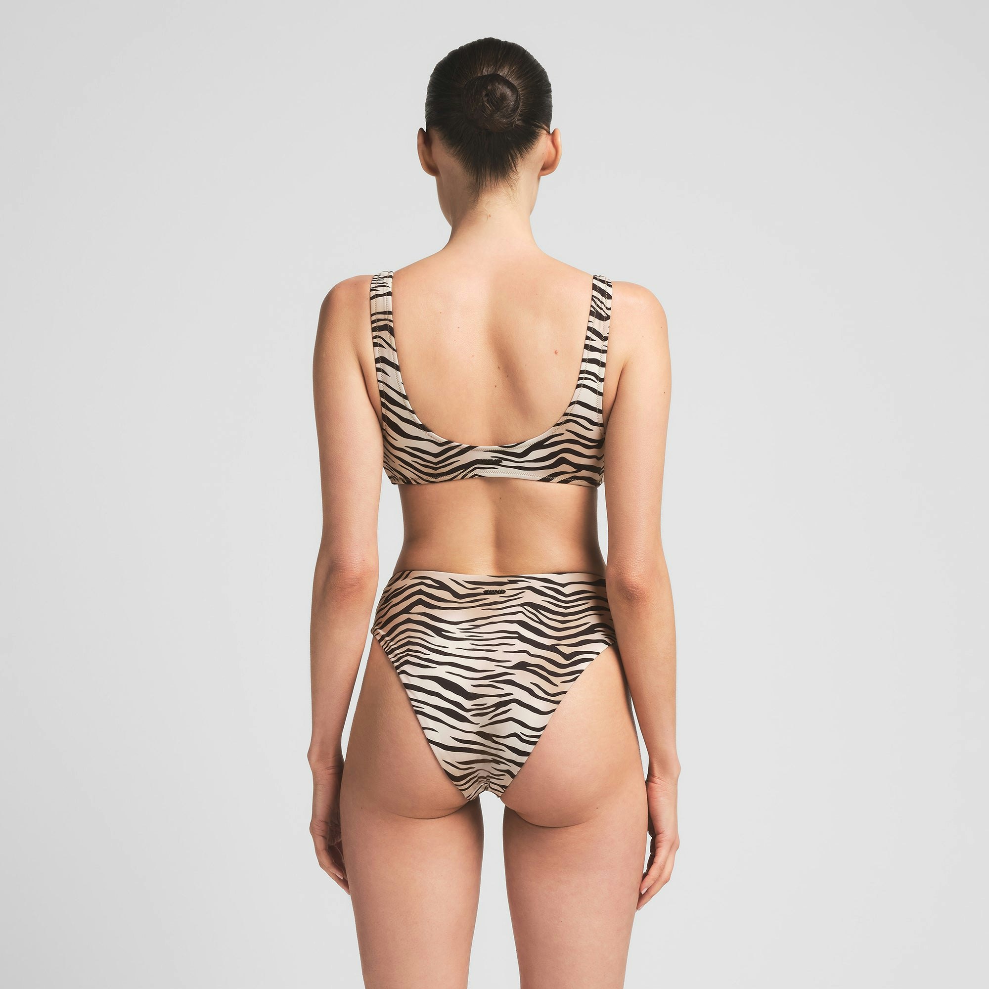 SIGNATURE SWIM HIGH-WAISTED BRIEF BIKINI BOTTOM | CHAMPAGNE TIGER PRINT ON A MODEL BACK VIEW | FOCUS: 0.0, 1.0, 0.9