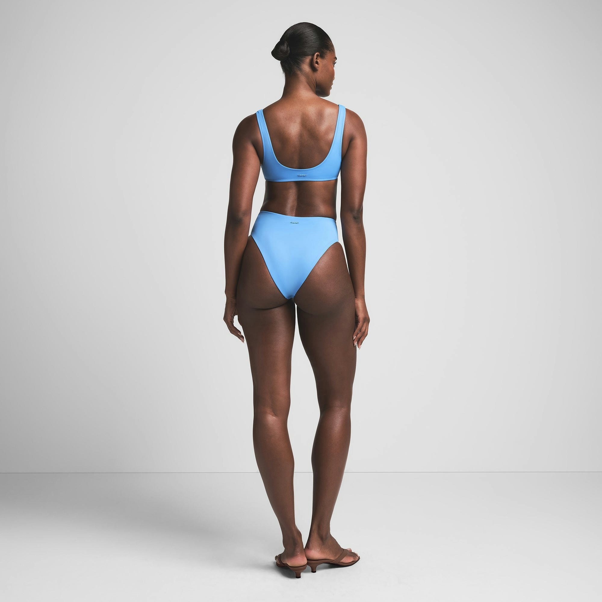 SIGNATURE SWIM HIGH-WAISTED BRIEF BIKINI BOTTOM | TIDE ON A MODEL BACK VIEW | FOCUS: 0.0, 1.0, 0.9