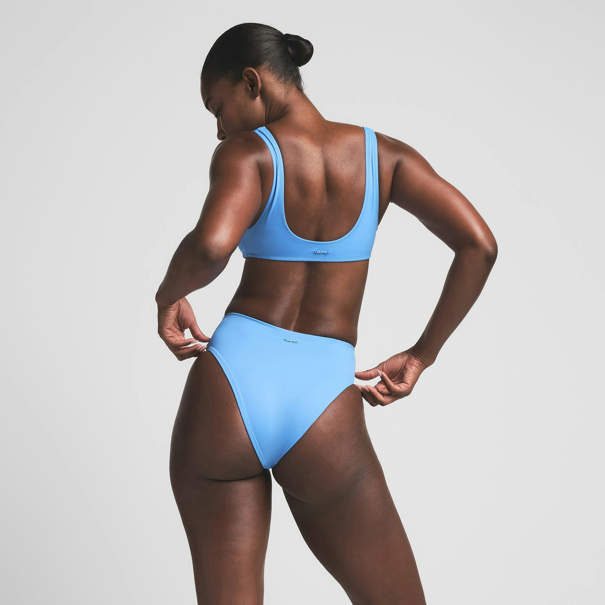 SIGNATURE SWIM HIGH-WAISTED BRIEF BIKINI BOTTOM | TIDE ON A MODEL BACK VIEW | FOCUS: 0.0, 1.0, 0.9