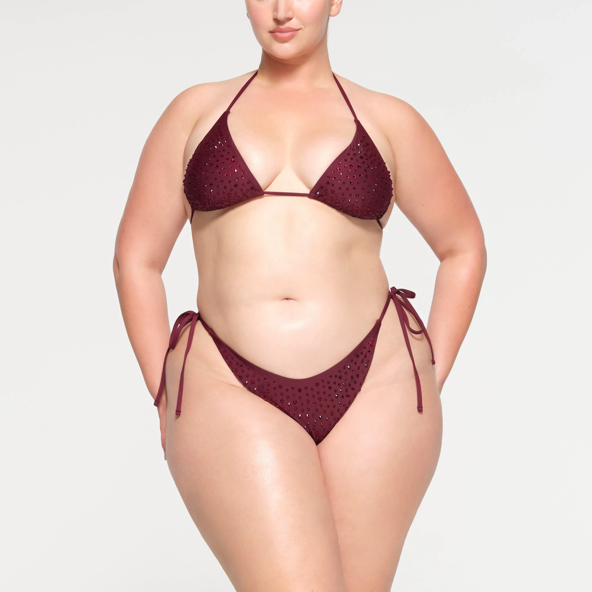 RHINESTONE TIE BIKINI BOTTOMS WORN BY A MODEL IN FRONT VIEW