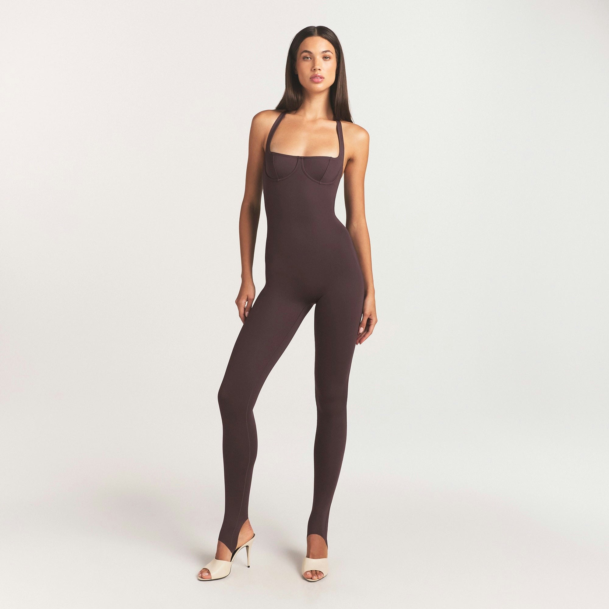 SKIMS BODY HALTER STIRRUP CATSUIT | RAISIN ON A MODEL FRONT VIEW @ | FOCUS: 0.0, 1.0, 0.9