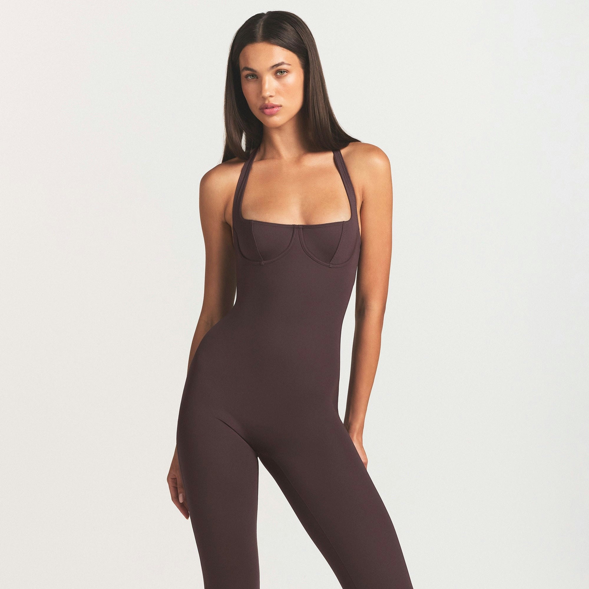 SKIMS BODY HALTER STIRRUP CATSUIT | RAISIN ON A MODEL SIDE VIEW @ | FOCUS: 0.0, 1.0, 0.9