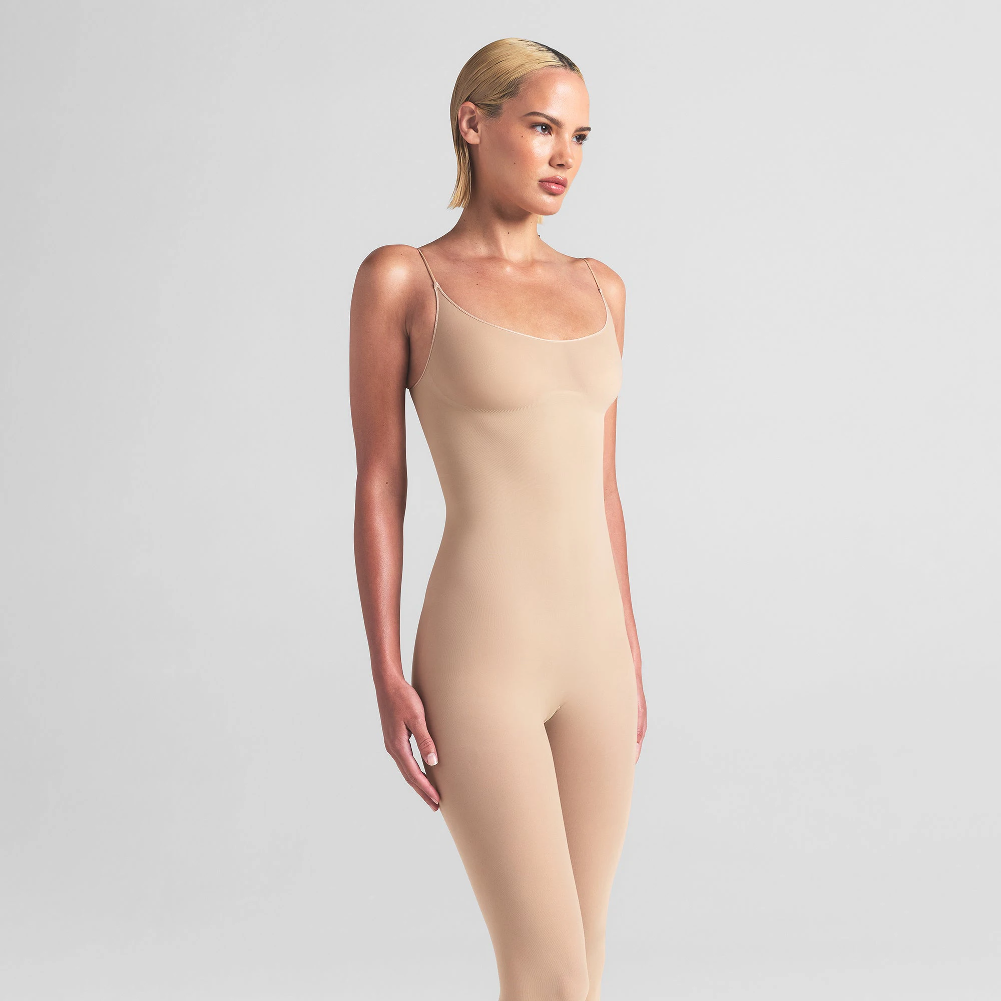 SHEER SEAMLESS CATSUIT | SAND ON A MODEL FRONT VIEW | FOCUS: 0.0, 1.0, 0.9