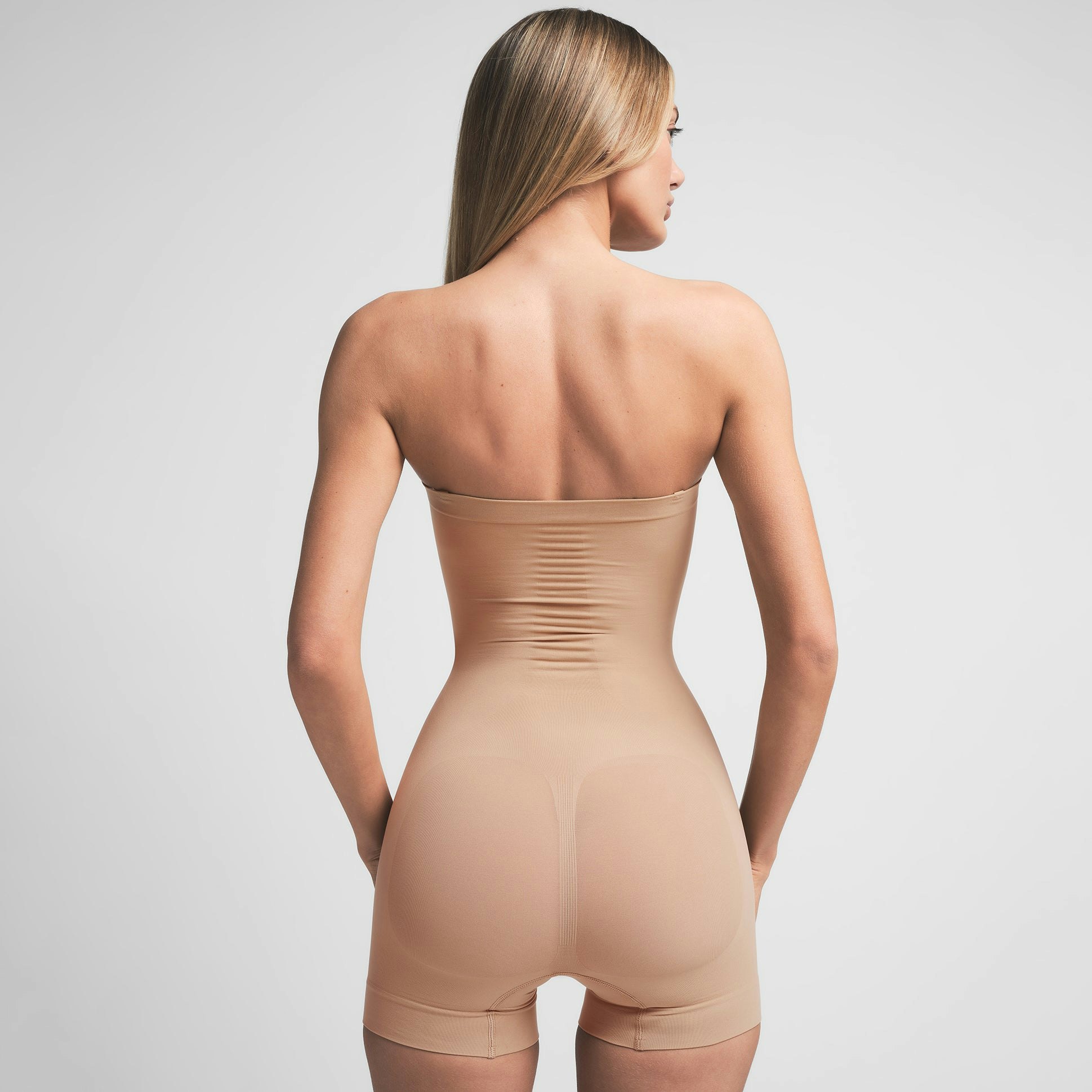 SEAMLESS SCULPT STRAPLESS SHORTIE BODYSUIT | CLAY ON A MODEL BACK VIEW | FOCUS: 0.0, 1.0, 0.9