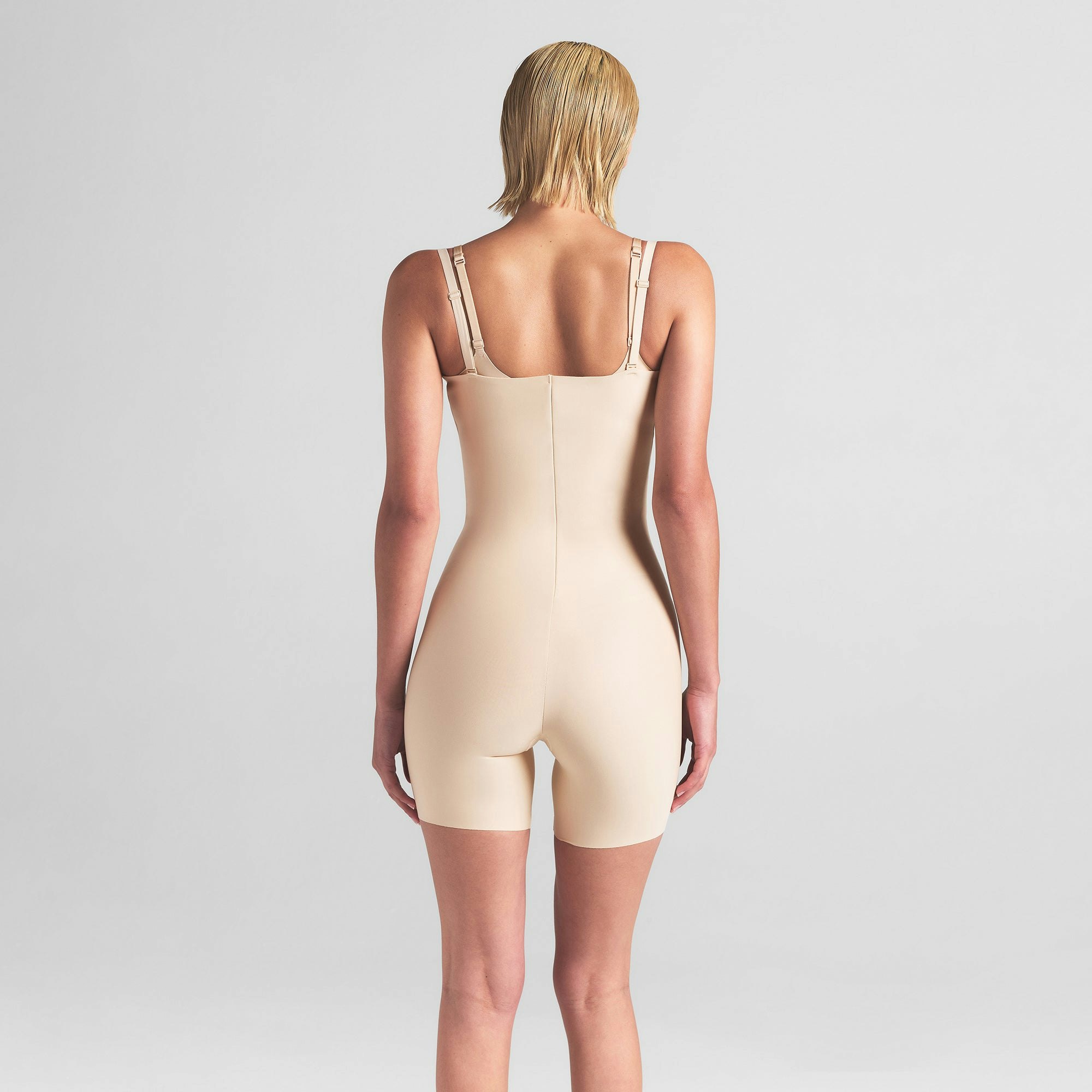 SKIMS BODY CORE SCULPT OPEN BUST MID THIGH BODYSUIT | SAND ON A MODEL BACK VIEW | FOCUS: 0.0, 1.0, 0.9