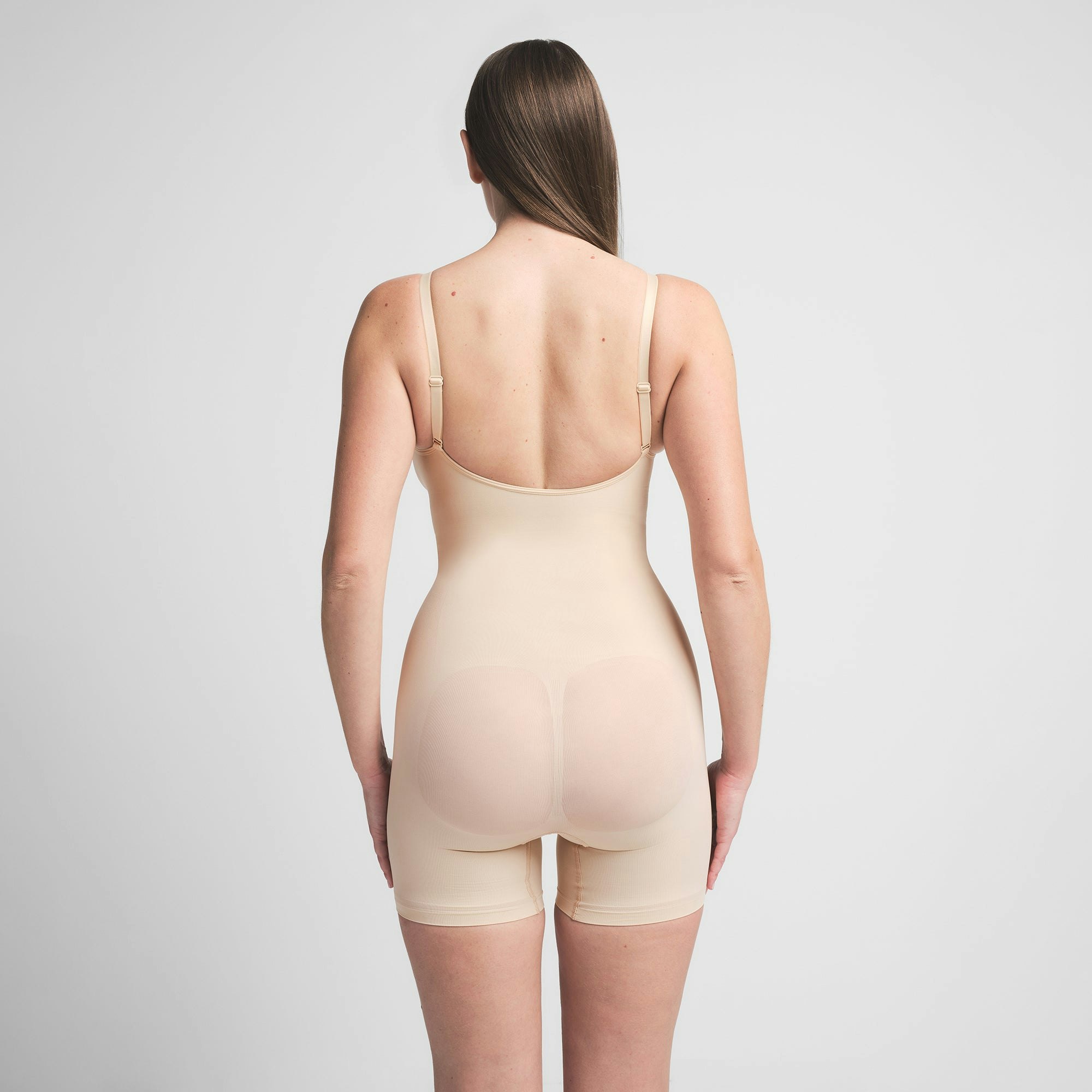 SEAMLESS SCULPT MID THIGH BODYSUIT | SAND ON A MODEL BACK VIEW | FOCUS: 0.0, 1.0, 0.9