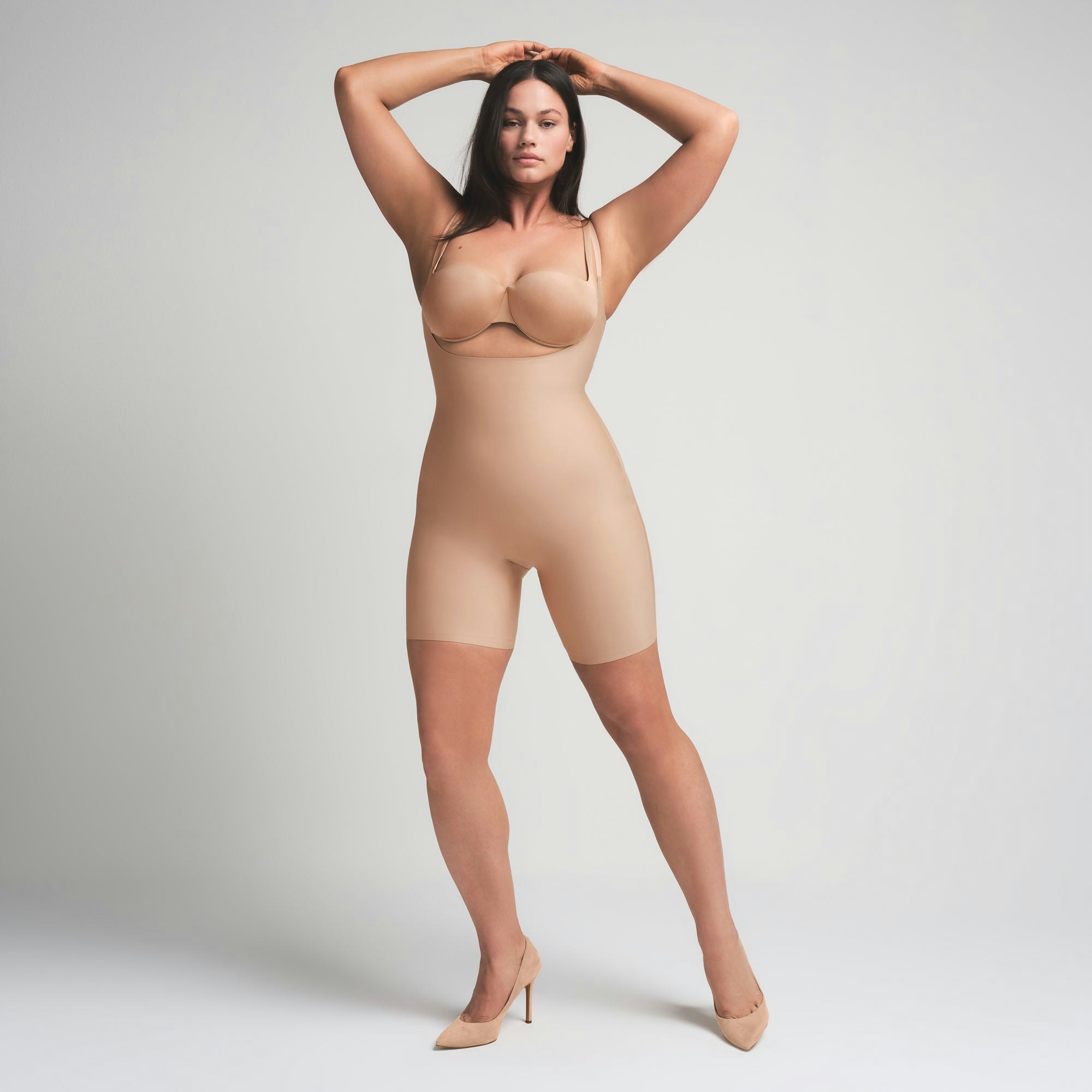 SKIMS BODY BUTT ENHANCING OPEN BUST PADDED BODYSUIT | CLAY ON A MODEL FRONT VIEW