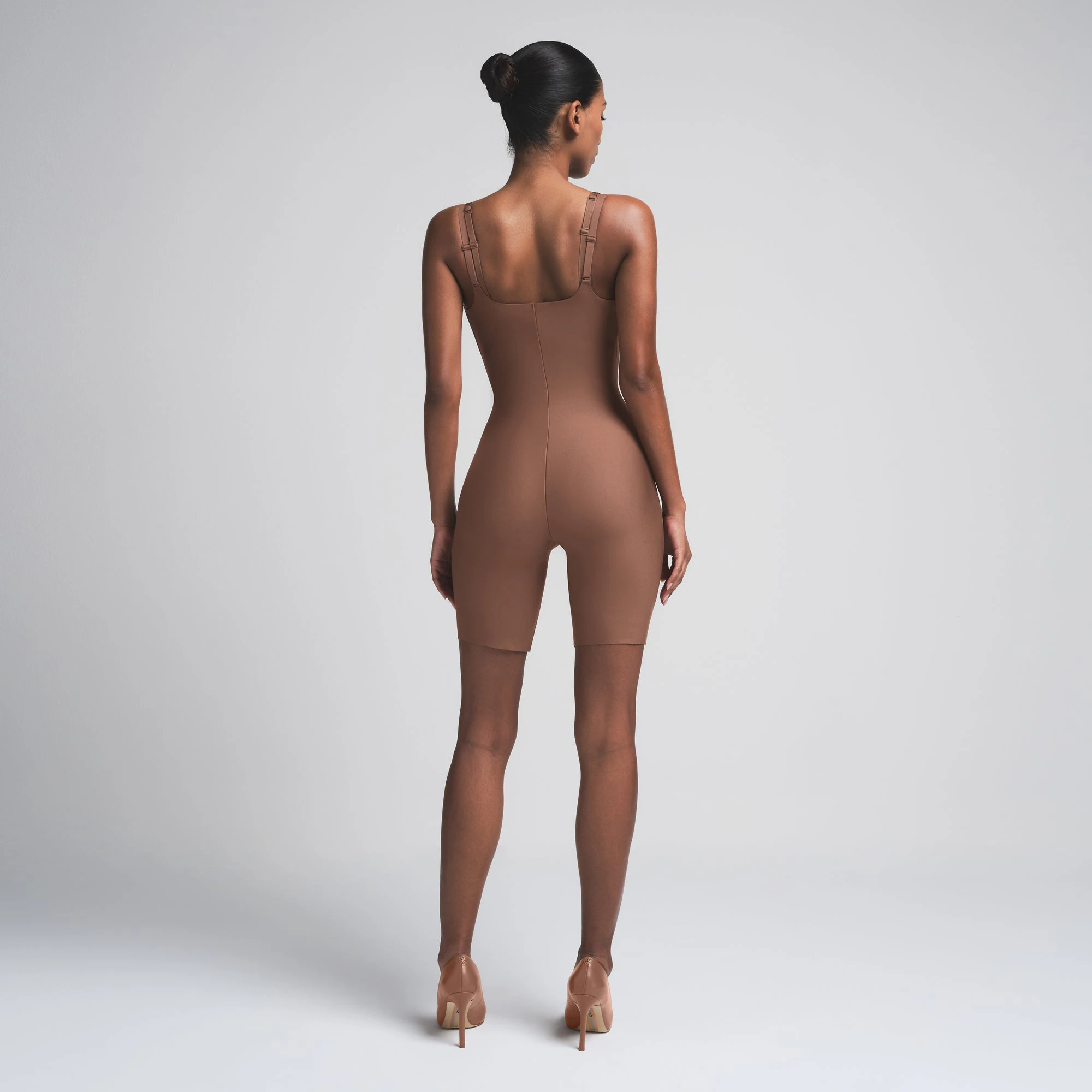 SKIMS BODY BUTT ENHANCING OPEN BUST PADDED BODYSUIT | JASPER ON A MODEL FRONT VIEW