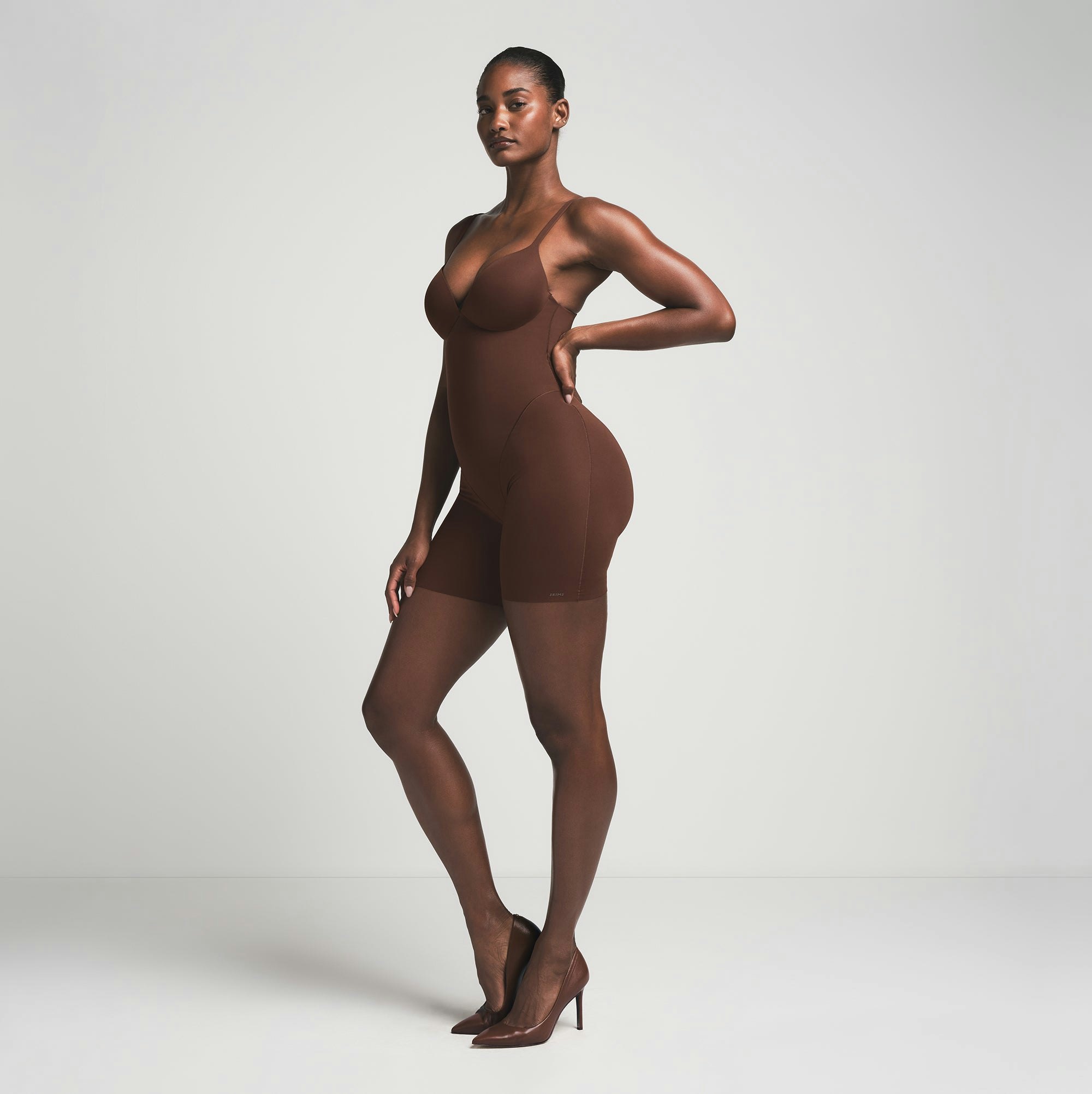 SKIMS ULTIMATE BODY PUSH-UP BUTT ENHANCING PADDED MID THIGH BODYSUIT | COCOA  ON A MODEL SIDE VIEW | FOCUS: 0.0, 1.0, 0.9