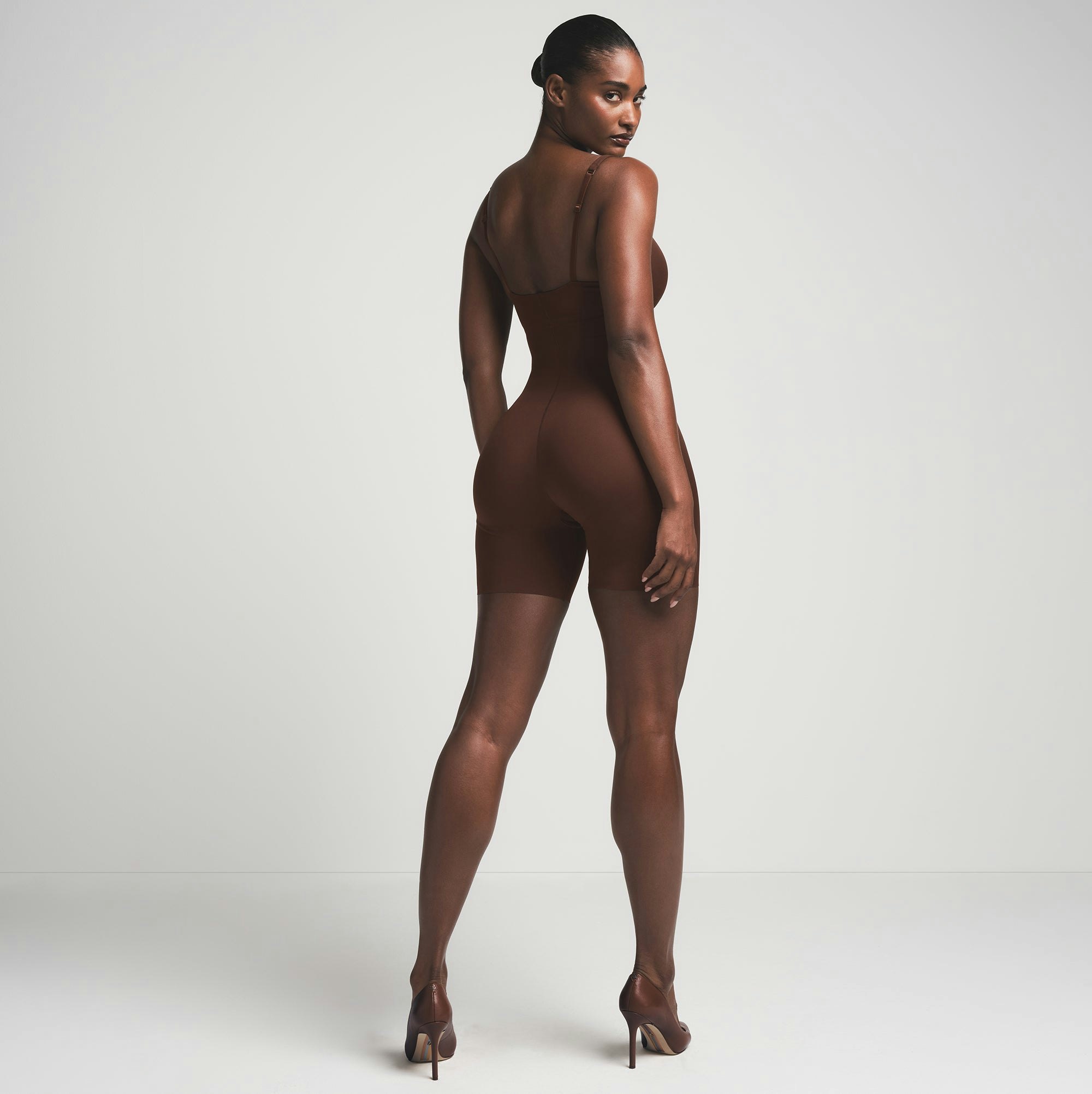 SKIMS ULTIMATE BODY PUSH-UP BUTT ENHANCING PADDED MID THIGH BODYSUIT | COCOA  ON A MODEL BACK VIEW | FOCUS: 0.0, 1.0, 0.9