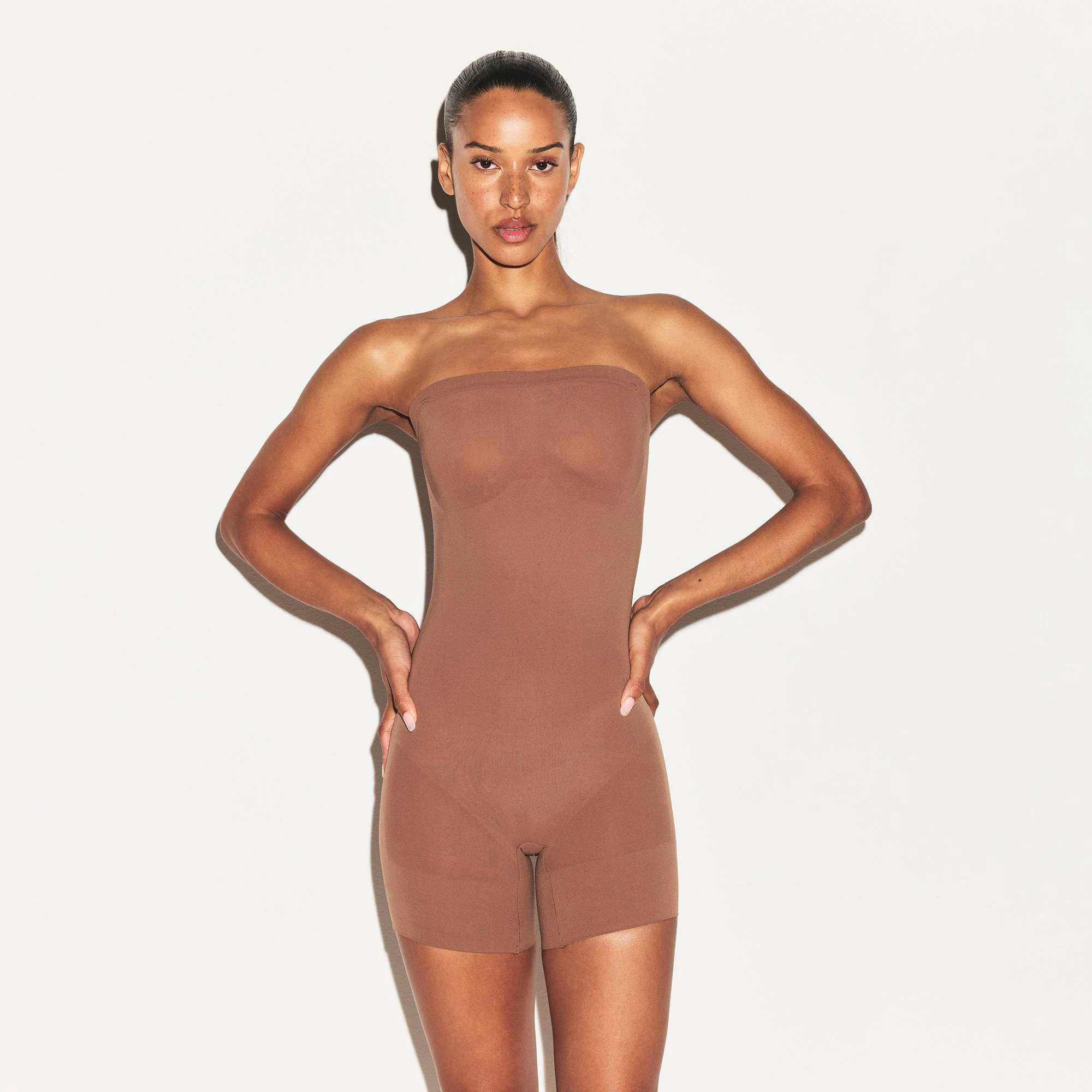 SHEER SEAMLESS STRAPLESS SHORTIE BODYSUIT | JASPER ON A MODEL FRONT VIEW | FOCUS: 0.9, 0.1, 0.7