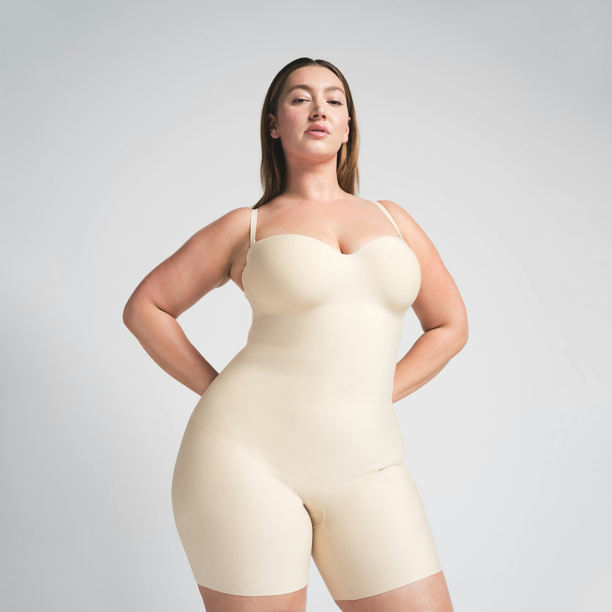 SKIMS BODY CORE SCULPT UNDERWIRE MID THIGH BODYSUIT | SAND ON A MODEL FRONT VIEW @ | FOCUS: 0.0, 1.0, 0.9