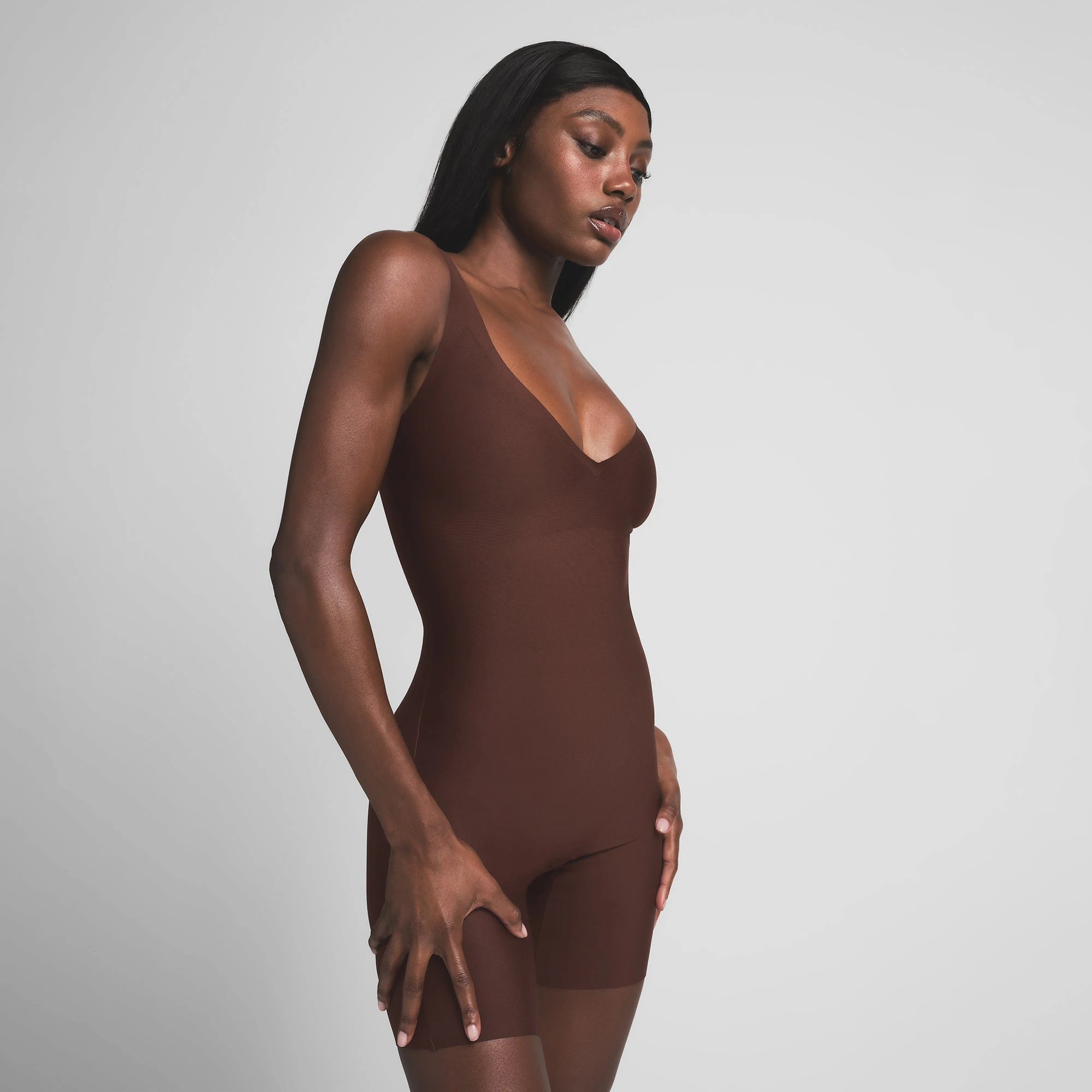 SKIMS BODY CORE SCULPT PLUNGE MID THIGH BODYSUIT | COCOA ON A MODEL SIDE VIEW | FOCUS: 0.0, 1.0, 0.9