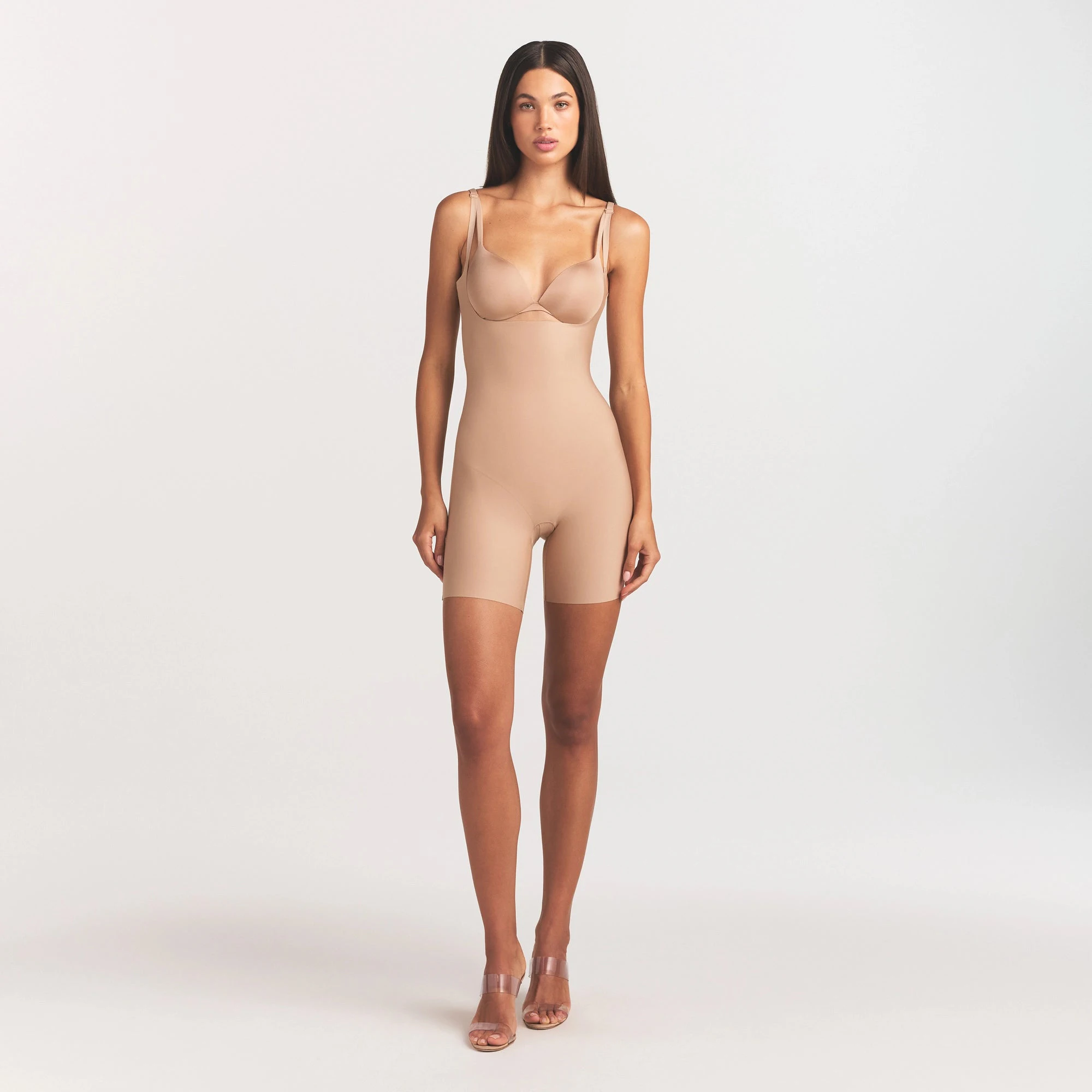 SKIMS BODY CORE SCULPT BACK SMOOTHING OPEN BUST MID THIGH BODYSUIT | CLAY ON A MODEL FRONT VIEW @