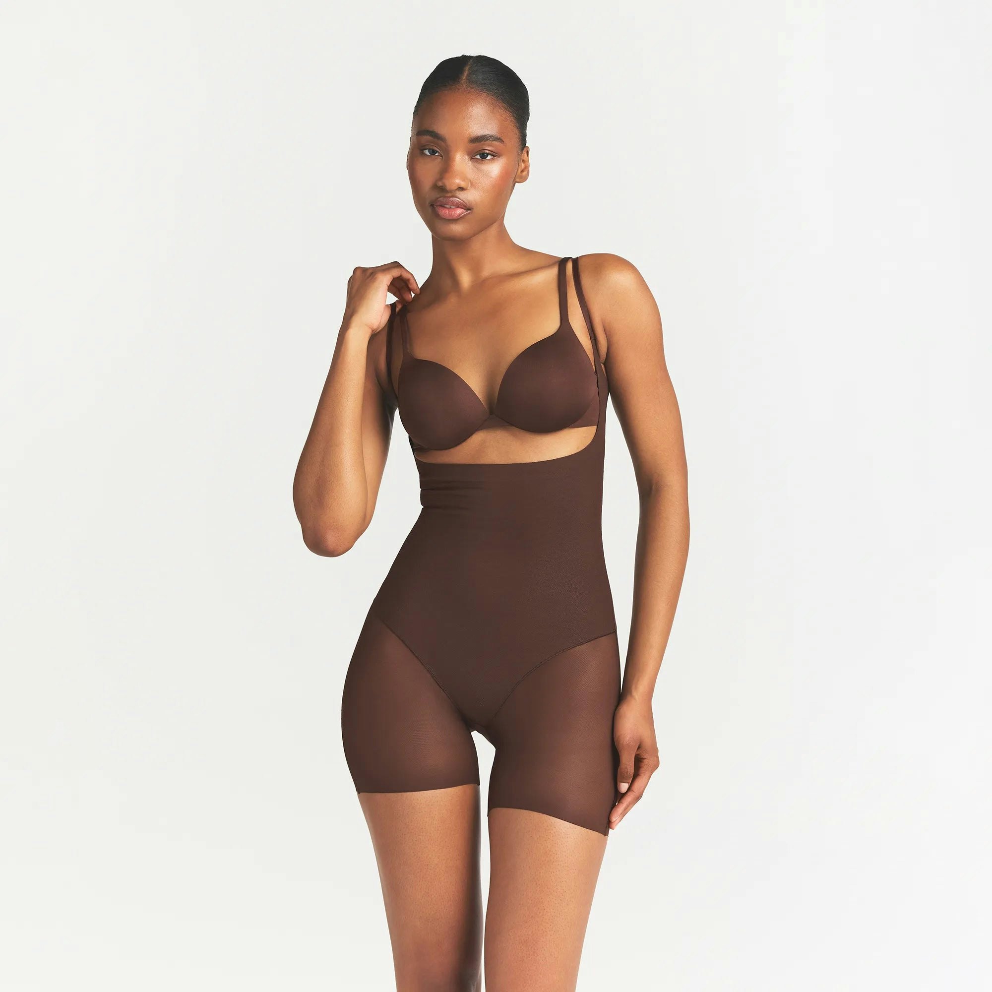 SKIMS BODY CORE SCULPT BACK SMOOTHING OPEN BUST MID THIGH BODYSUIT | COCOA ON A MODEL FRONT VIEW @ | FOCUS: 0.0, 1.0, 0.9