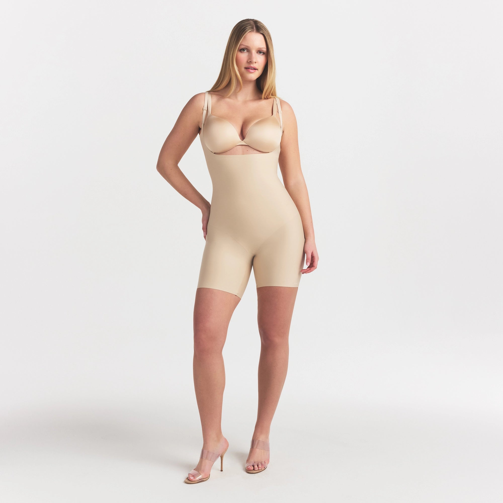 SKIMS BODY CORE SCULPT BACK SMOOTHING OPEN BUST MID THIGH BODYSUIT | SAND ON A MODEL FRONT VIEW @ | FOCUS: 0.0, 1.0, 0.9