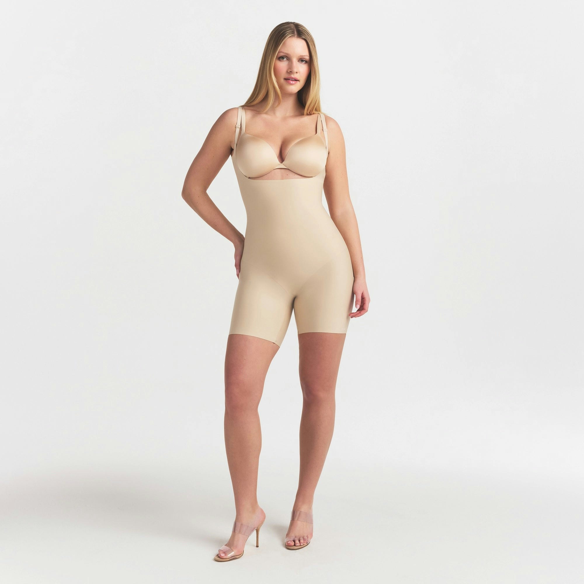 SKIMS BODY CORE SCULPT BACK SMOOTHING OPEN BUST MID THIGH BODYSUIT | SAND ON A MODEL FRONT VIEW @ | FOCUS: 0.0, 1.0, 0.9
